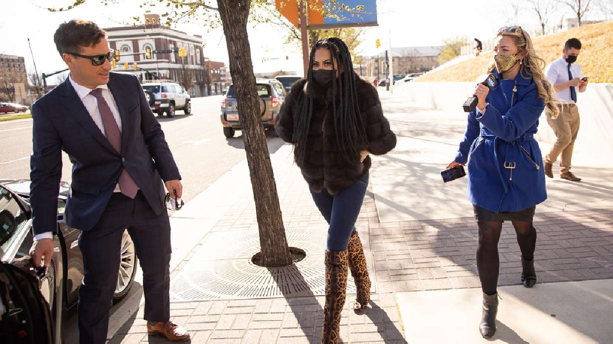 "The Real Housewives of Salt Lake City" star Jen Shah, center, leaves the U.S. District Court in Salt Lake City on March 30, 2021. Her prison sentence has been reduced by one year.