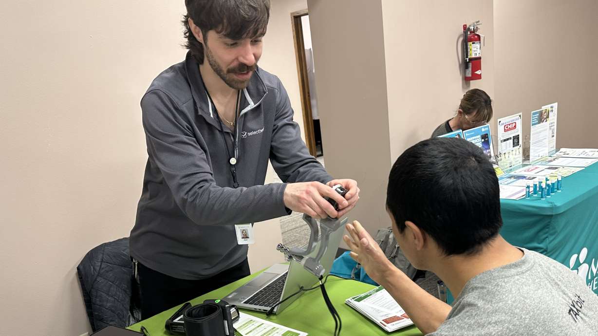 A man gets his blood pressure tested at the Ventanilla de Salud, a program that aims to improve Latino community's health by offering basic services in Spanish.