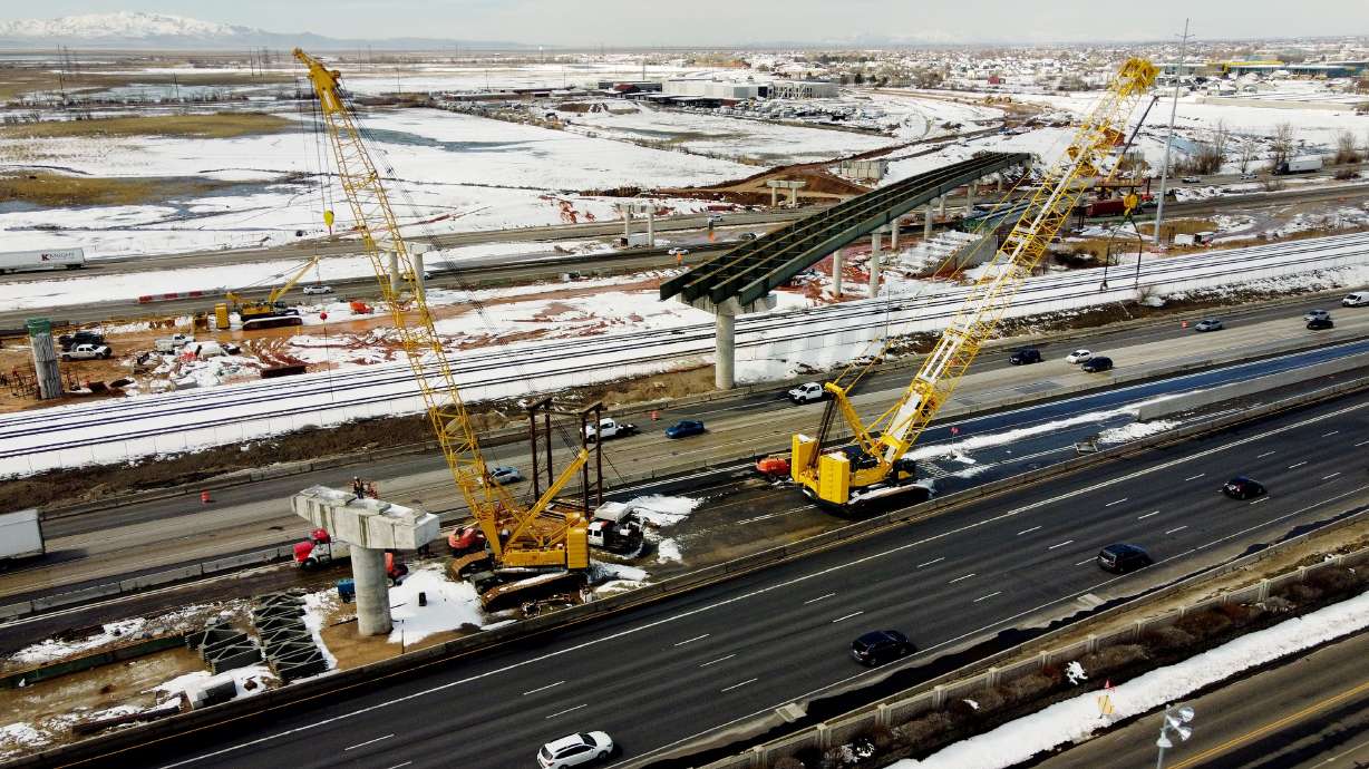 Workers construct a bridge over I-15 on the West Davis Corridor near Farmington on Tuesday. As of now, the West Davis Corridor project is 70% complete and on schedule to be completed for a 2024 opening.