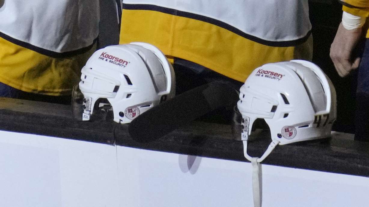 The logo of Nashville's Covenant School is displayed on the back of Nashville Predators' helmets in honor of the school shooting victims, before the team's NHL hockey game against the Boston Bruins, Tuesday, March 28, 2023, in Boston.