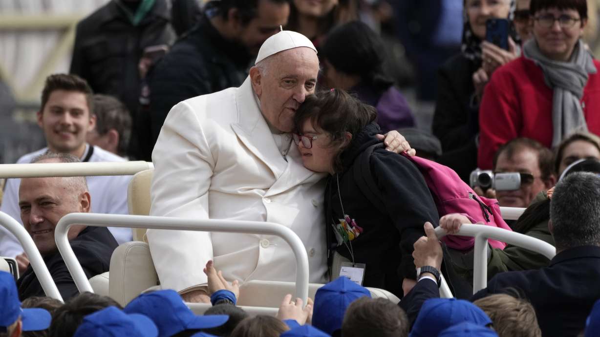 Pope Francis hugs a child at the end of his weekly general audience in St. Peter's Square, at the Vatican, Wednesday.