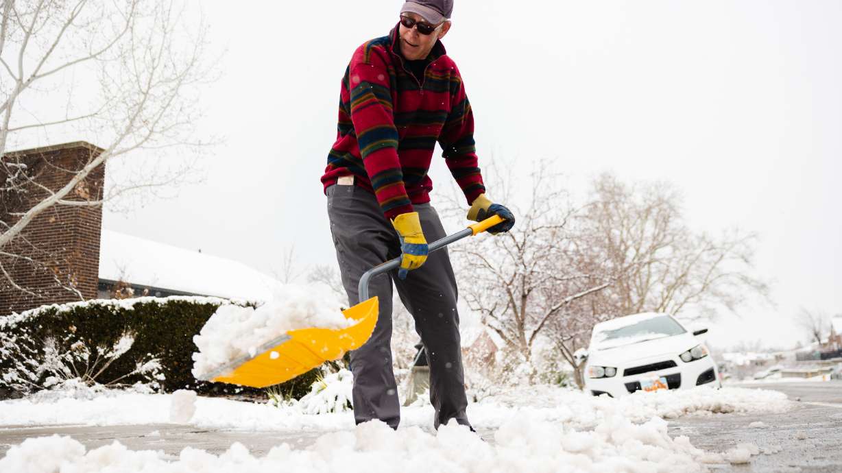 David Usher shovels snow in Salt Lake City on Friday. Utah's valleys may receive another inch or two this week, while the mountains may end up with another foot from the latest storm arriving in Utah.