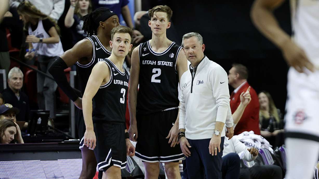 Utah State Aggies head coach Ryan Odom talks with forward Dan Akin (30), guard Steven Ashworth (3) and guard Sean Bairstow (2) during an Aztec free throw as Utah State and San Diego State play in the Mountain West Conference Basketball Tournament Championship at UNLV’s Thomas and Mack Center in Las Vegas on Saturday, March 11, 2023. San Diego State won 62-57.