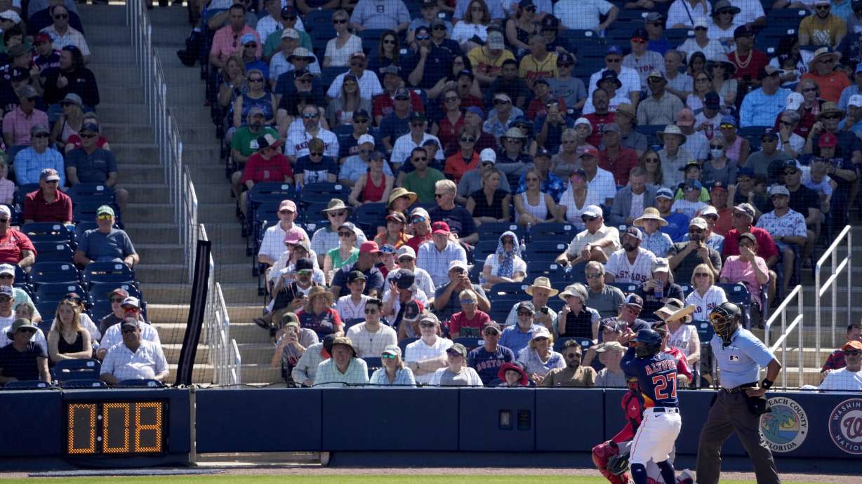 Houston Astros' Jose Altuve (27) bats as the pitch clock ticks down during the fifth inning of a spring training baseball game against the Boston Red Sox Wednesday, March 1, 2023, in West Palm Beach, Fla.