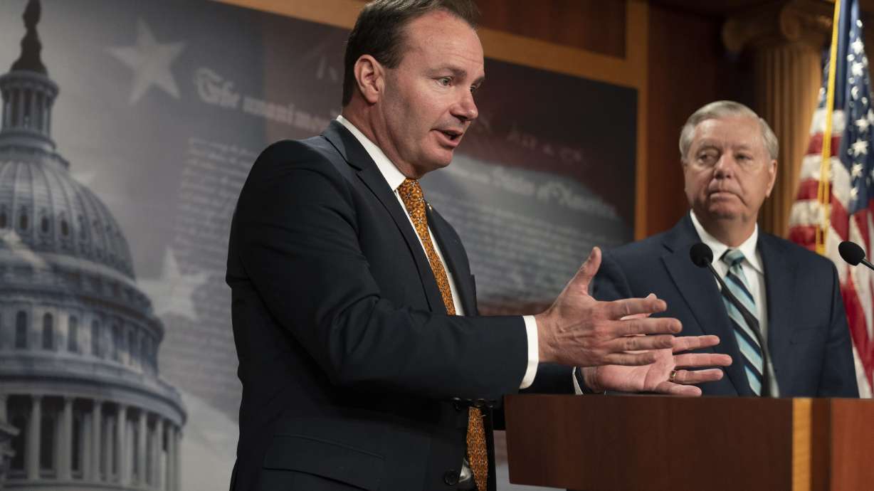 Sen. Lindsey Graham, R-S.C., and Sen. Mike Lee, R-Utah, Wednesday, on Capitol Hill in Washington. The Senate voted in favor of legislation that revokes the authority of presidents to use force in Iraq, returning the power to Congress.