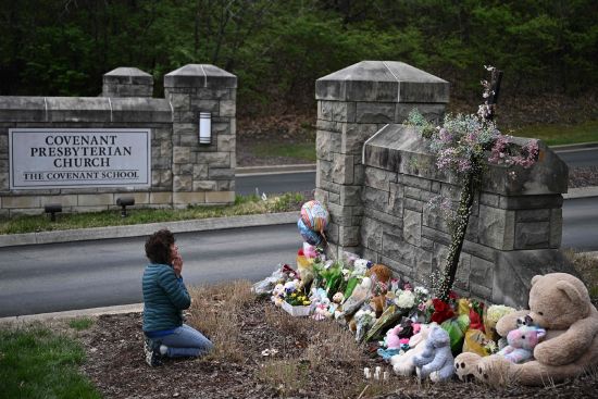 Robin Wolfenden prays at a makeshift memorial for victims outside the Covenant School building at the Covenant Presbyterian Church following a shooting, in Nashville, Tennessee, on Tuesday.