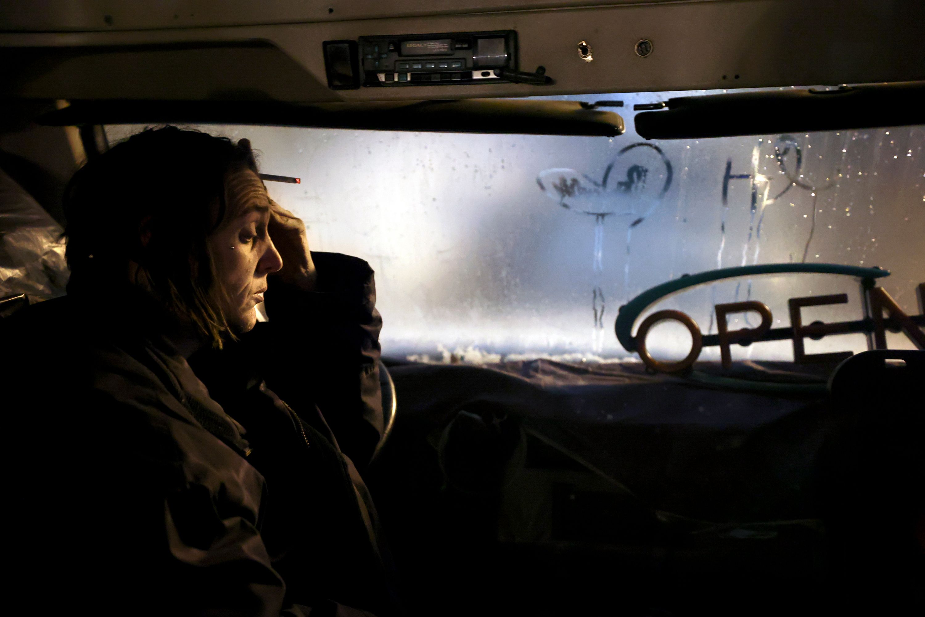 Barbara Elmer, who is unsheltered, is sick while sitting on the Nomad Alliance bus temporarily parked outside a meetinghouse of The Church of Jesus Christ of Latter-day Saints that is not in use on March 8. The bus shelters Utahns experiencing homelessness.