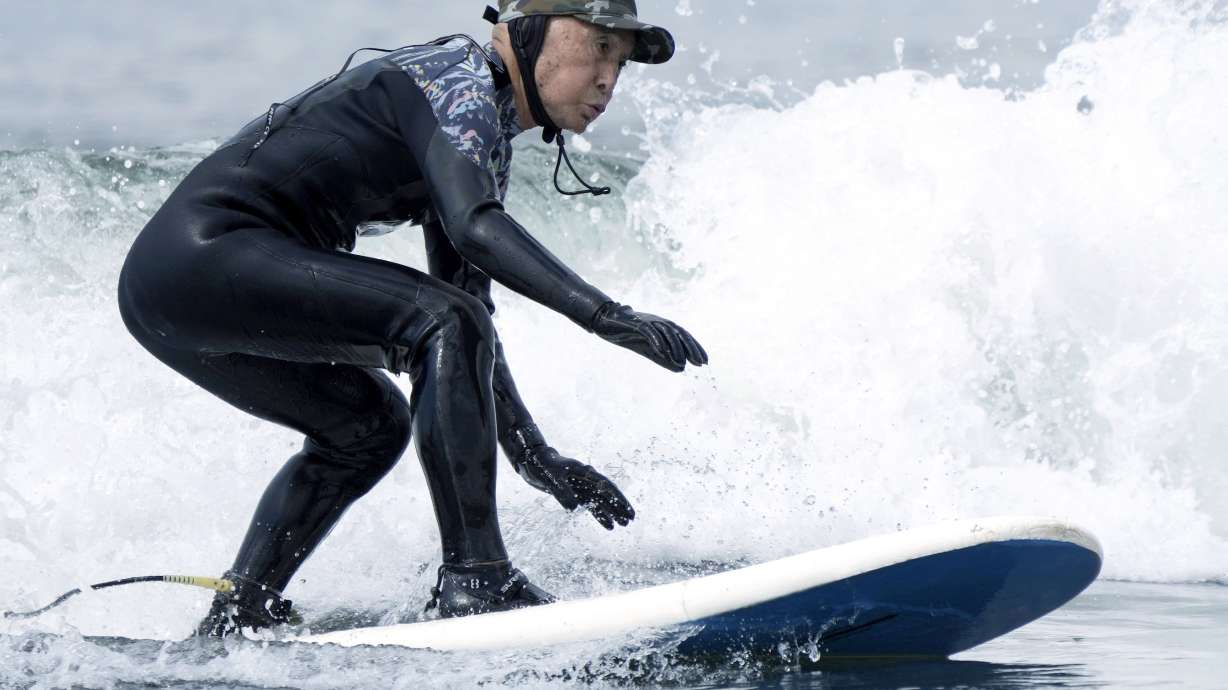 Seiichi Sano, an 89-year-old Japanese man, rides a wave at Katase Nishihama Beach, Thursday, March 30, 2023, in Fujisawa, south of Tokyo. Sano, who turns 90 later this year, has been recognized by the Guinness World Records as the oldest male to surf.