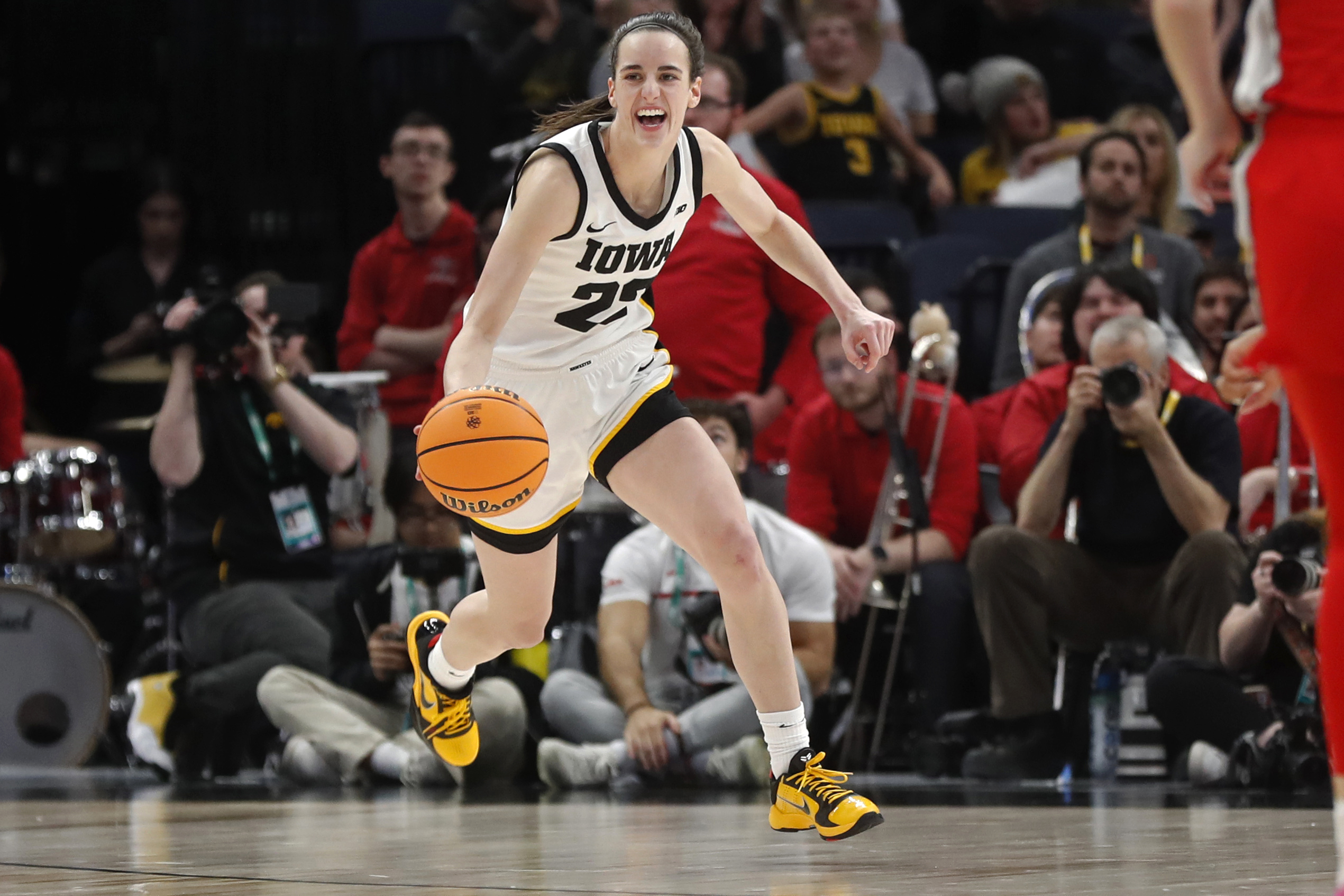 FILE - Iowa guard Caitlin Clark smiles after catching her 10th rebound to give her a triple-double against Ohio State in the second half of an NCAA college basketball championship game at the Big Ten women's tournament Sunday, March 5, 2023, in Minneapolis. Clark was honored Thursday, March 30, as The Associated Press women's college basketball Player of the Year.