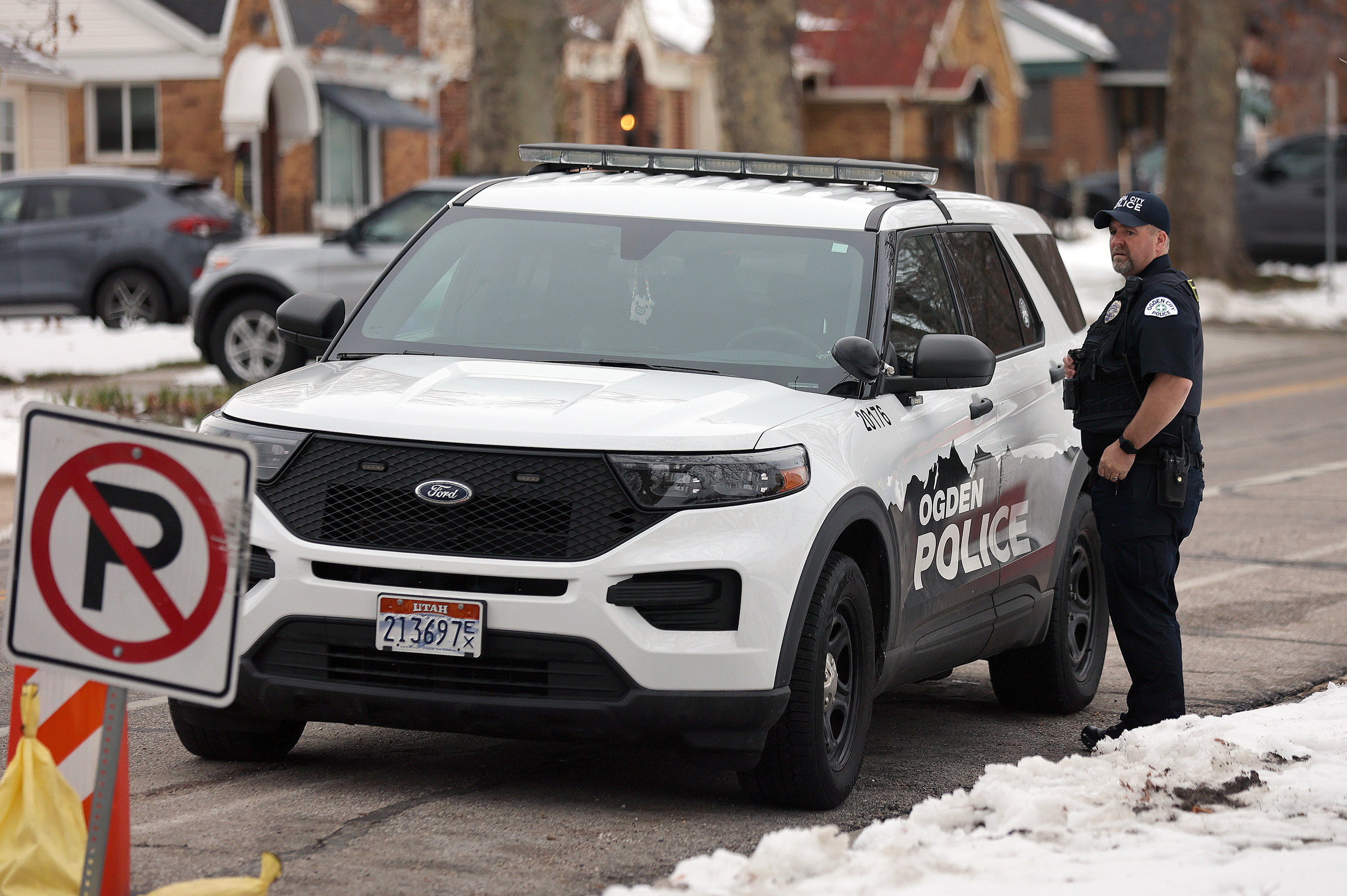 Ogden police officer Chavis Whitby walks to his car outside of Ogden High School after police responded to false threats of shots fired on Wednesday. Investigators say the calls made in Utah are similar to ones received in Rhode Island.