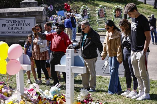Fitzgerald Moore leads a group in prayer at a memorial at the entrance to The Covenant School on Wednesday in Nashville, Tennessee.