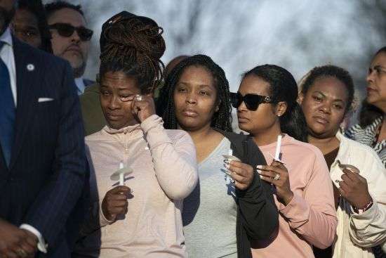 A mourner wipes away a tear during the Nashville Remembers candlelight vigil to mourn and honor the victims of The Covenant School mass shooting at Public Square Park Wednesday in Nashville, Tennessee.