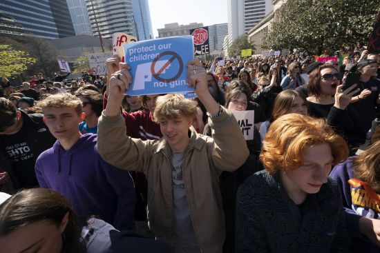 Sully Wilson raises his sign during a Rally of Parents and Kids to End Gun Violence at the State Capitol in Nashville, Tennessee, Thursday.