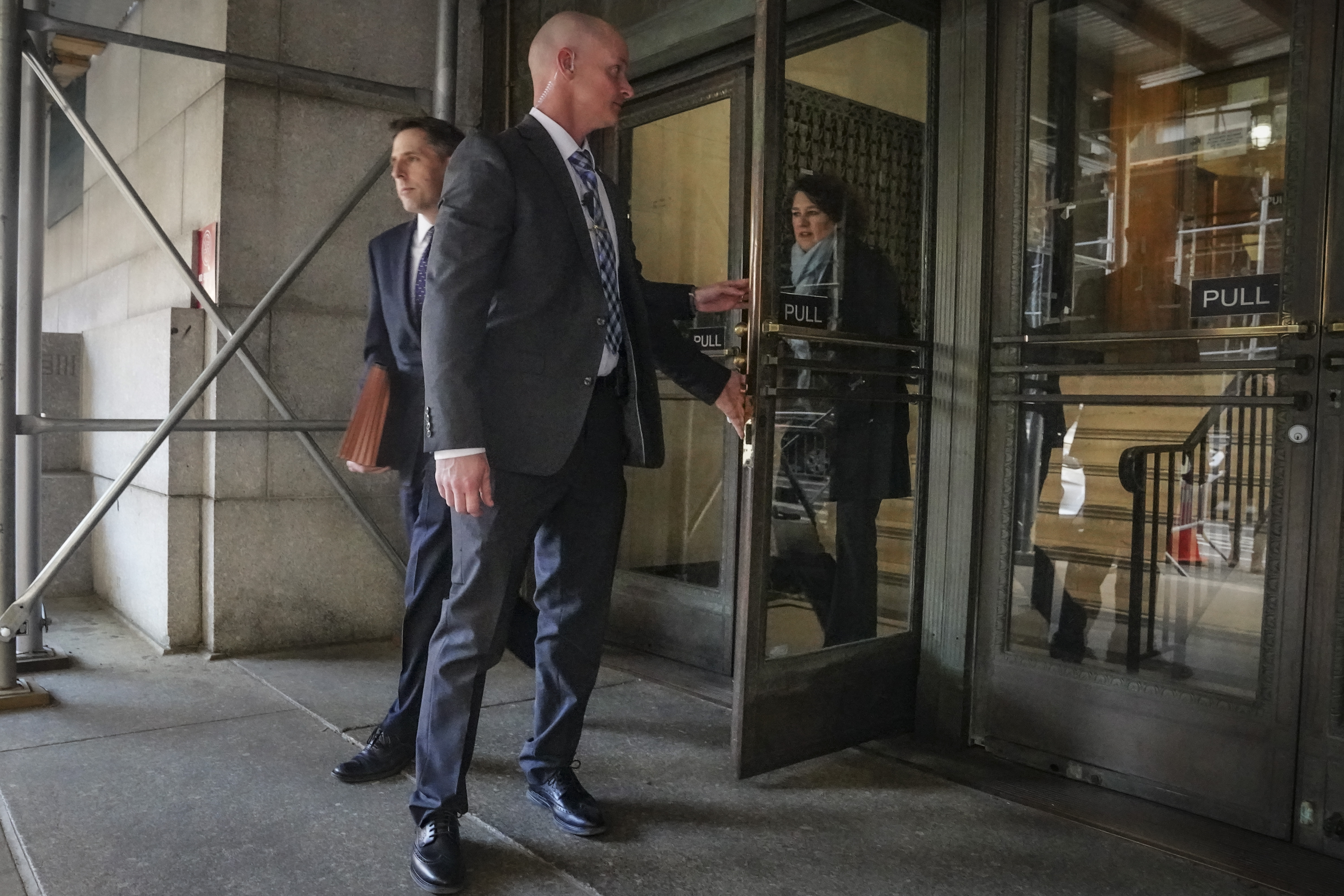Prosecutors Matthew Colangelo, left, and Susan Hoffinger, right, leave a state office building, Thursday in New York. Donald Trump has been indicted in New York on charges involving payments made during the 2016 presidential campaign to silence claims of an extramarital sexual encounter.