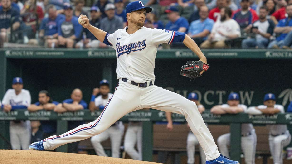 Texas Rangers starting pitcher Jacob deGrom throws against the Philadelphia Phillies during the first inning of an opening day baseball game, Thursday, March 30, 2023, in Arlington, Texas.