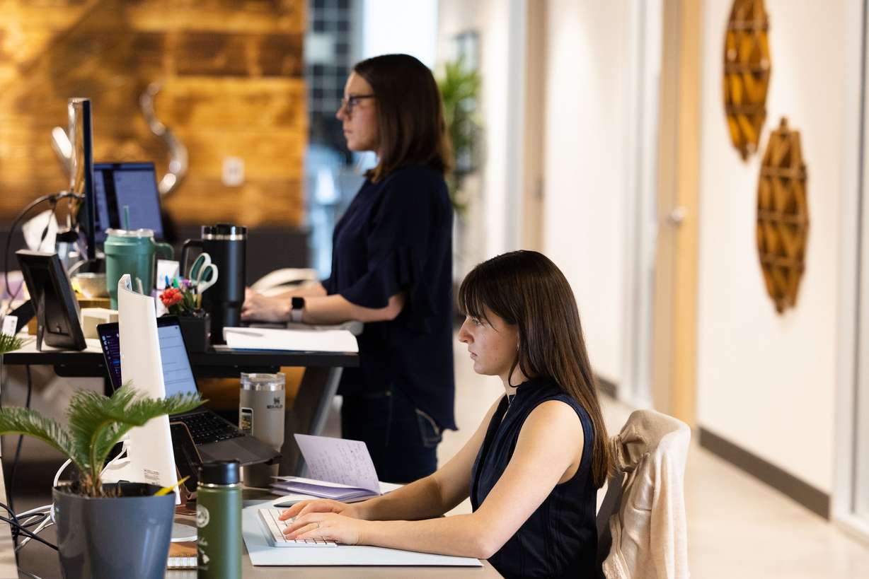 Rebecca Trusty, community and content associate, and Brianna Bowles, director of operations, right to left, work at Kickstart Fund in Cottonwood Heights on March 13.