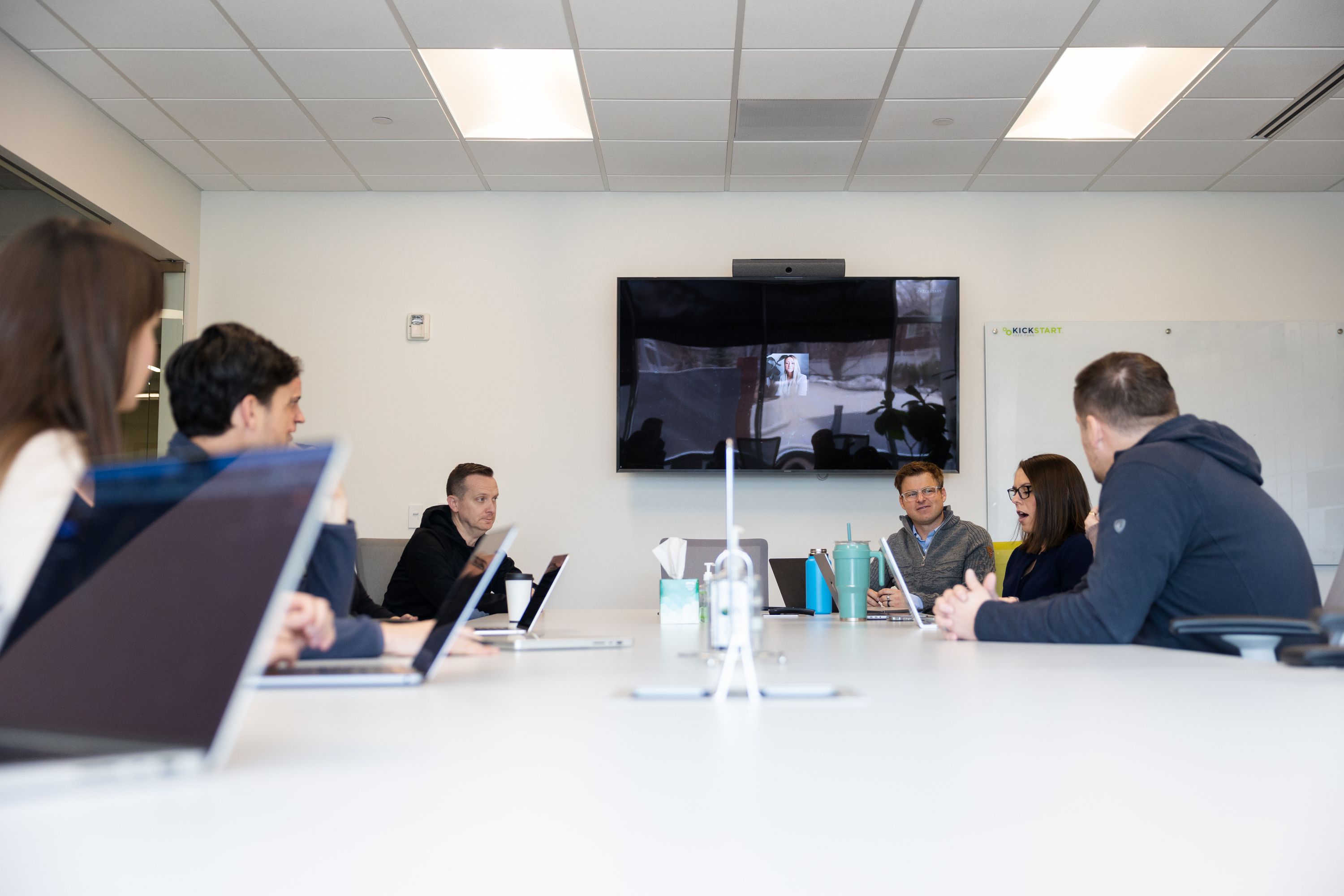 Team members meet during a partner’s meeting at Kickstart Fund in Cottonwood Heights on March 13.