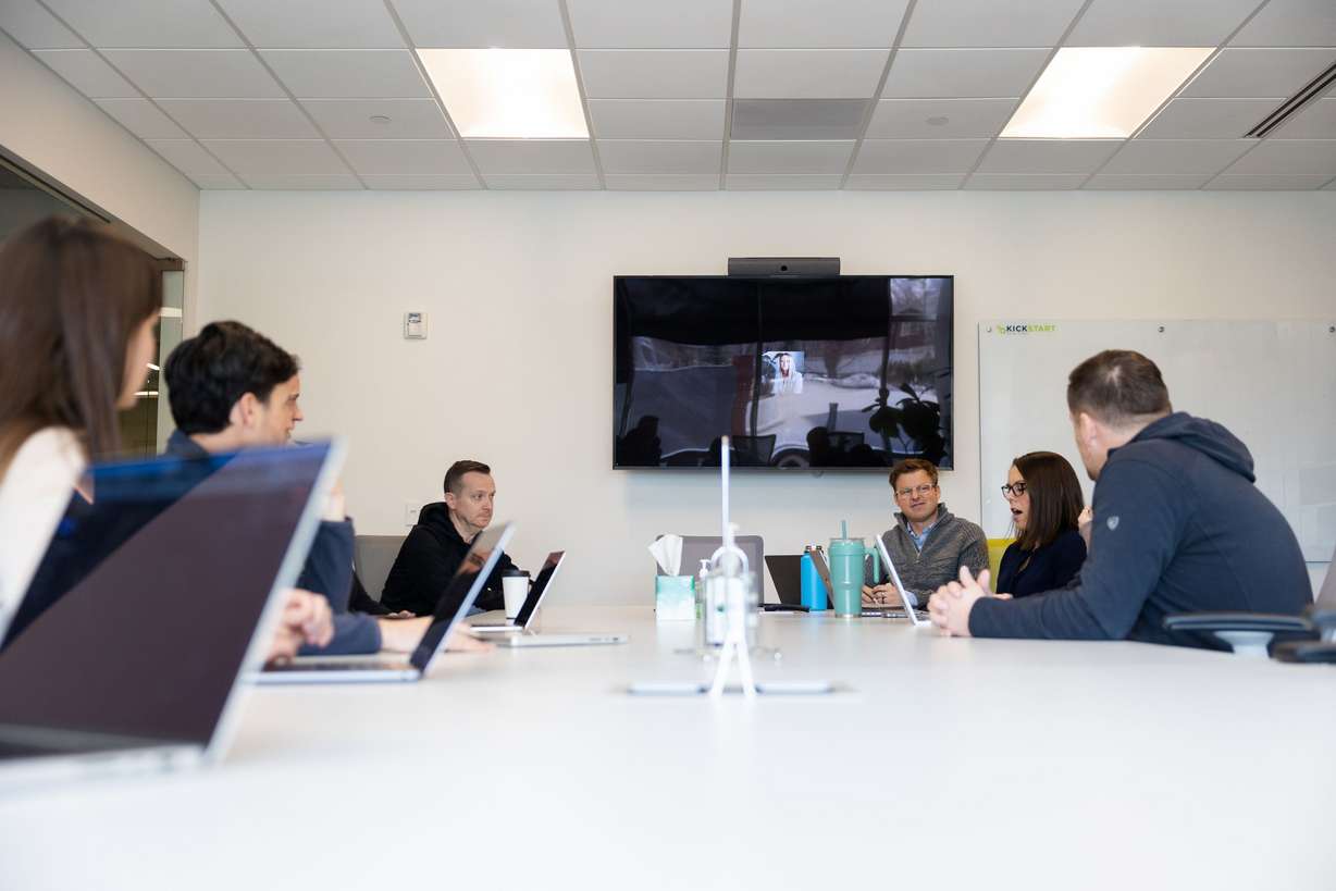 Team members meet during a partner’s meeting at Kickstart Fund in Cottonwood Heights on March 13.