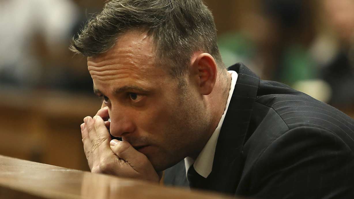 FILE - Oscar Pistorius speaks on a mobile phone in the High Court in Pretoria, South Africa, June 15, 2016 during his sentencing hearing for murdering girlfriend Reeva Steenkamp. Pistorius has applied for parole and is expected to attend a hearing on Friday, March 31, 2023 that will decide if the former Olympic runner is released from prison 10 years after killing girlfriend Reeva Steenkamp.