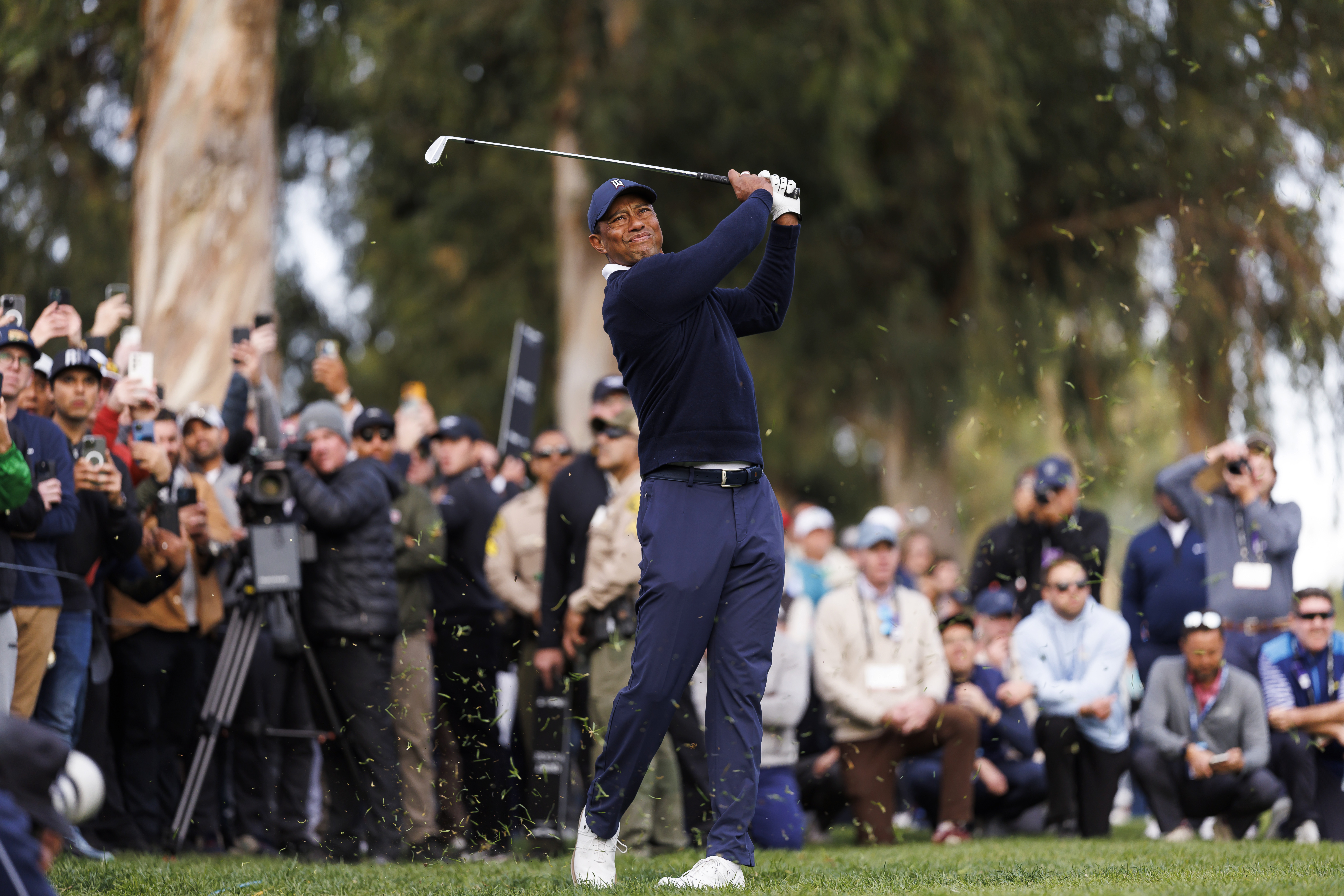 FILE - Tiger Woods hits his second shot on the 13th hole during the first round of the Genesis Invitational golf tournament at Riviera Country Club, Feb. 16, 2023, in the Pacific Palisades area of Los Angeles. Fans now flock to Woods wondering if it might be their last chance.