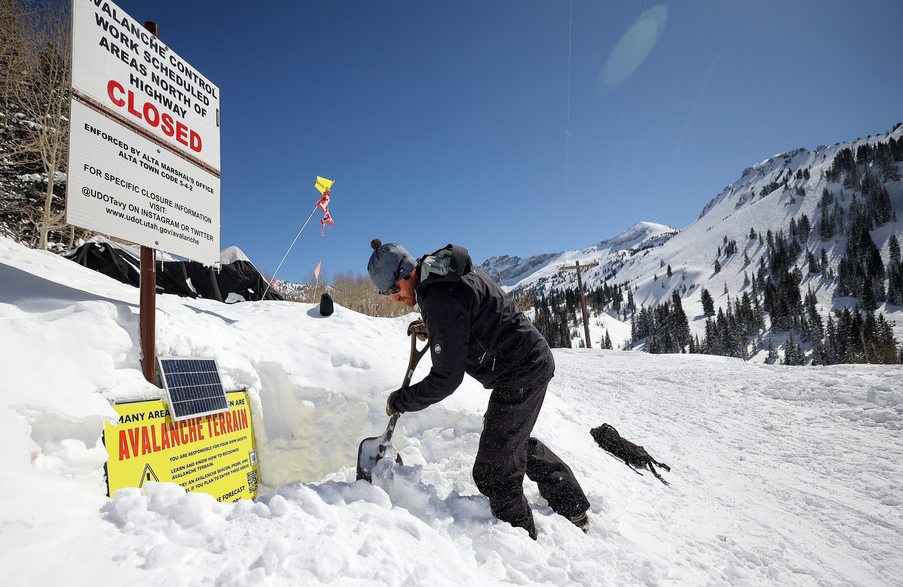 Utah Avalanche Center avalanche forecaster Dave Kelly shovels out a buried sign in Alta, on March 16. Alta Ski Area reported Friday that it has now received more than 800 inches of snowfall since October.