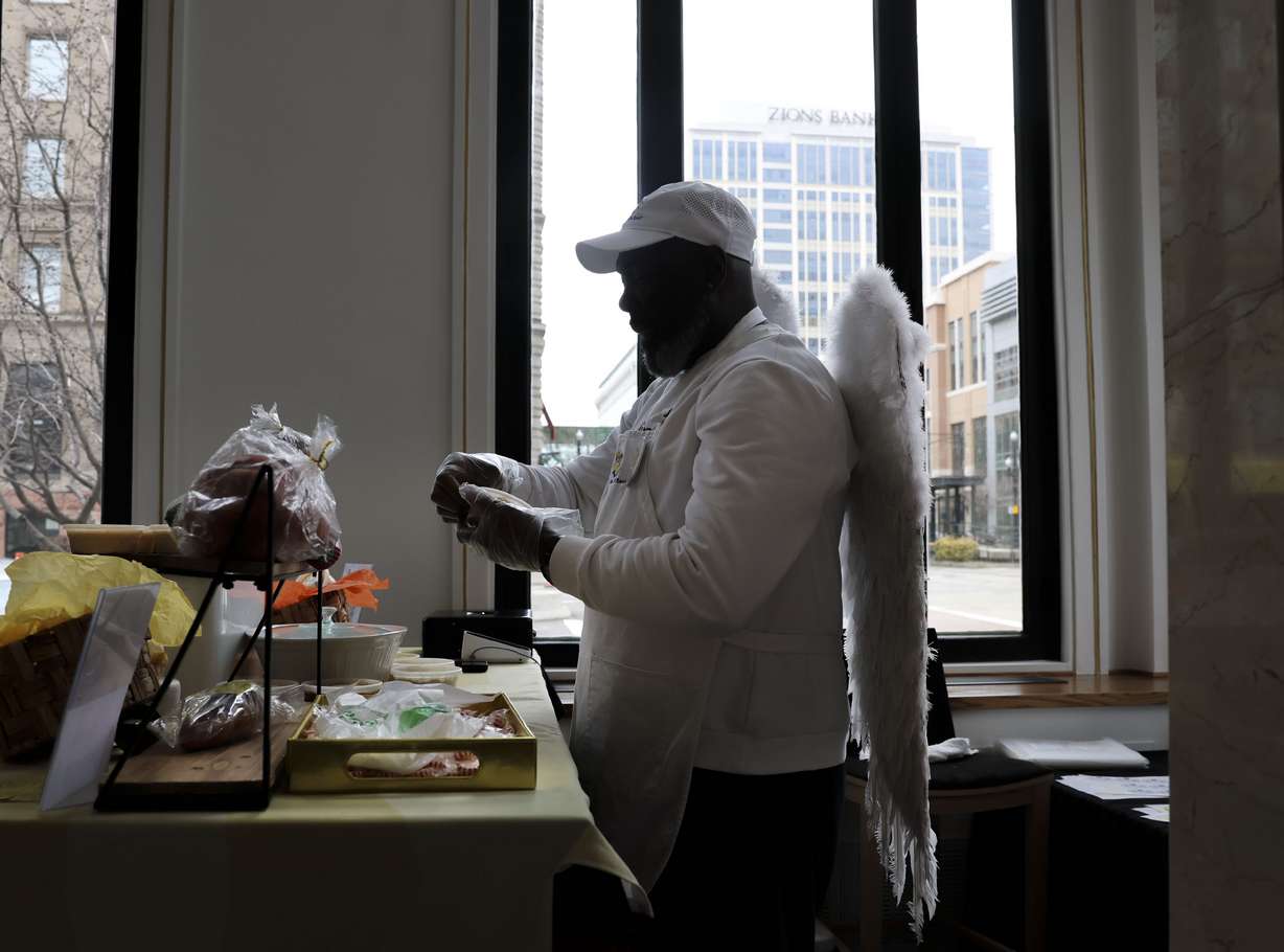 Lavarro Greer wears his wings while working at his shop, Heaven’s Best Flavored Butters, at the Utah Black Chamber's "Black and Open for Business" at the Zions Bank Eagle Emporium on Main Street in Salt Lake City on Friday. The marketplace runs Fridays and Saturdays from 10 a.m. to 6 p.m. through Saturday, April 8.