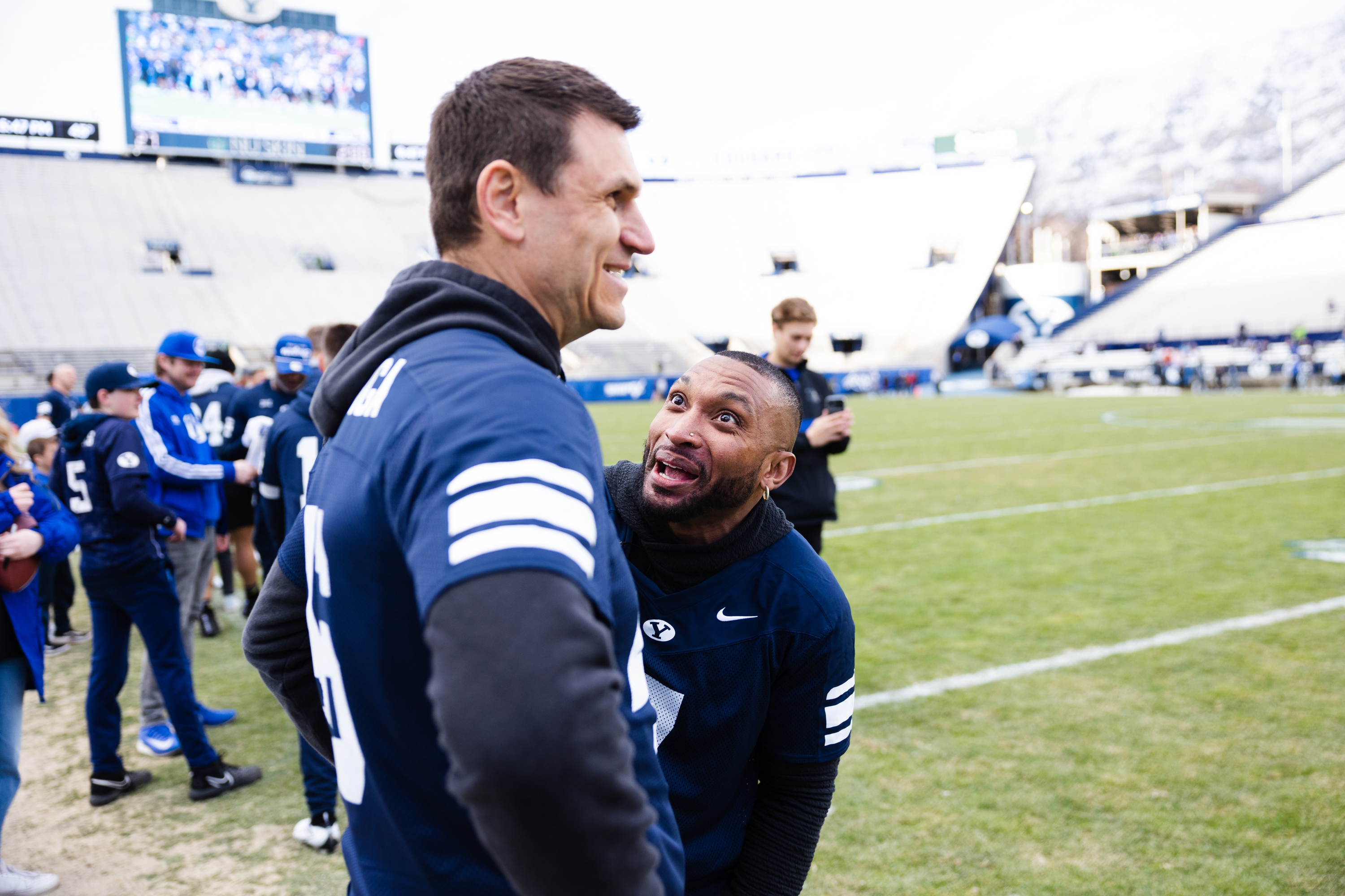 Brigham Young alumnus Brian Logan talks to teammate Kelly Poppinga during the Brigham Young University alumni game at LaVell Edwards Stadium in Provo on March 31, 2023.