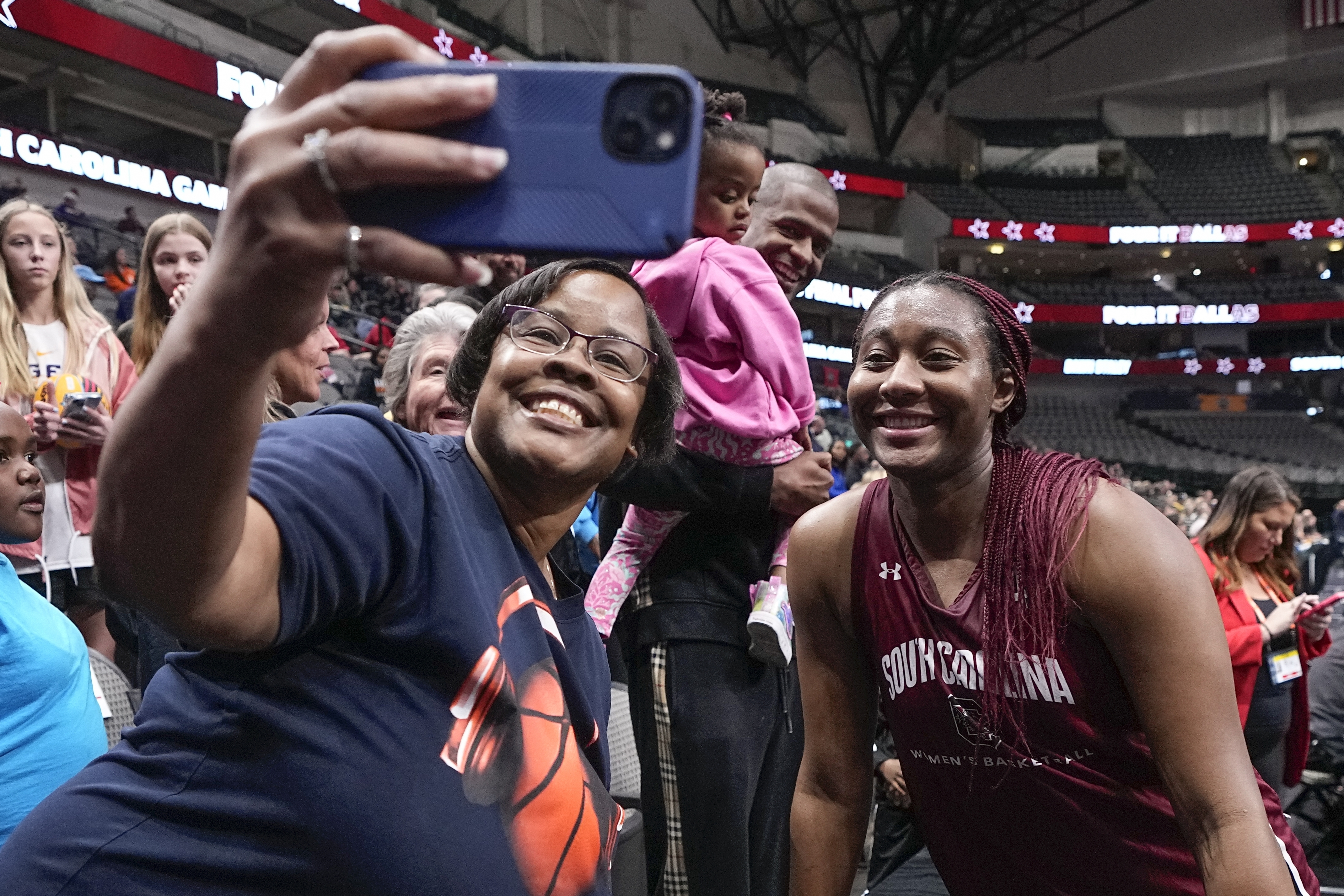 South Carolina's Aliyah Boston takes a selfie with a fan after a practice session for an NCAA Women's Final Four semifinals basketball game Thursday, March 30, 2023, in Dallas.