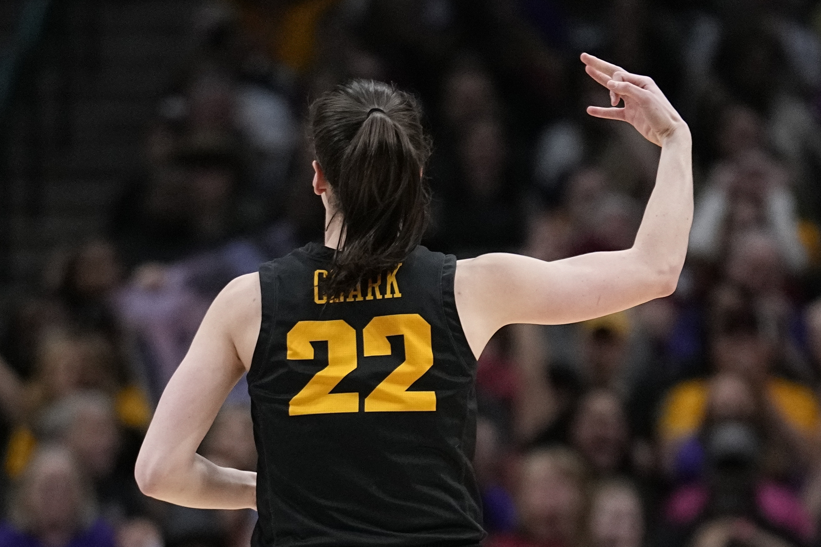 Iowa's Caitlin Clark reacts after a three pointer during the second half of an NCAA Women's Final Four semifinals basketball game against South CarolinaFriday, March 31, 2023, in Dallas.