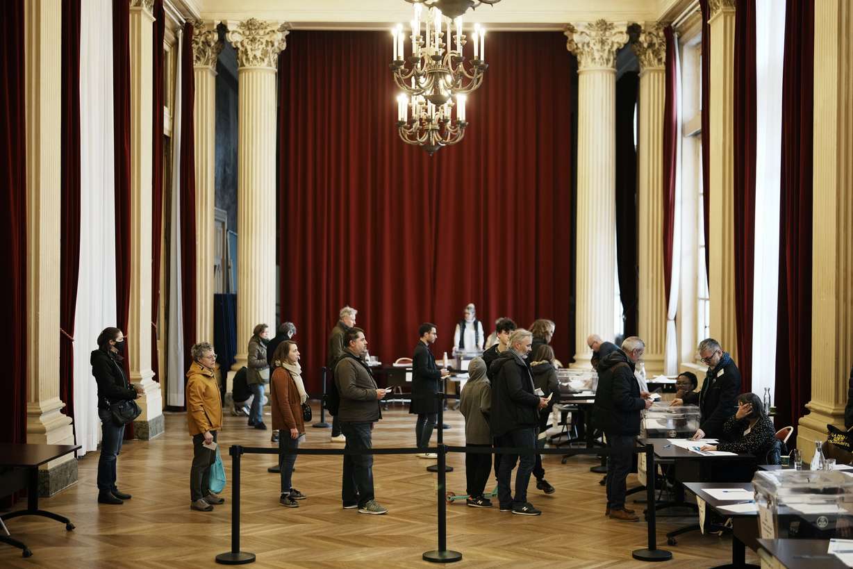 People queue to vote in a citywide mini-referendum: "For or against self-service scooters in Paris?" at the city hall of the 10th district of Paris, Sunday.