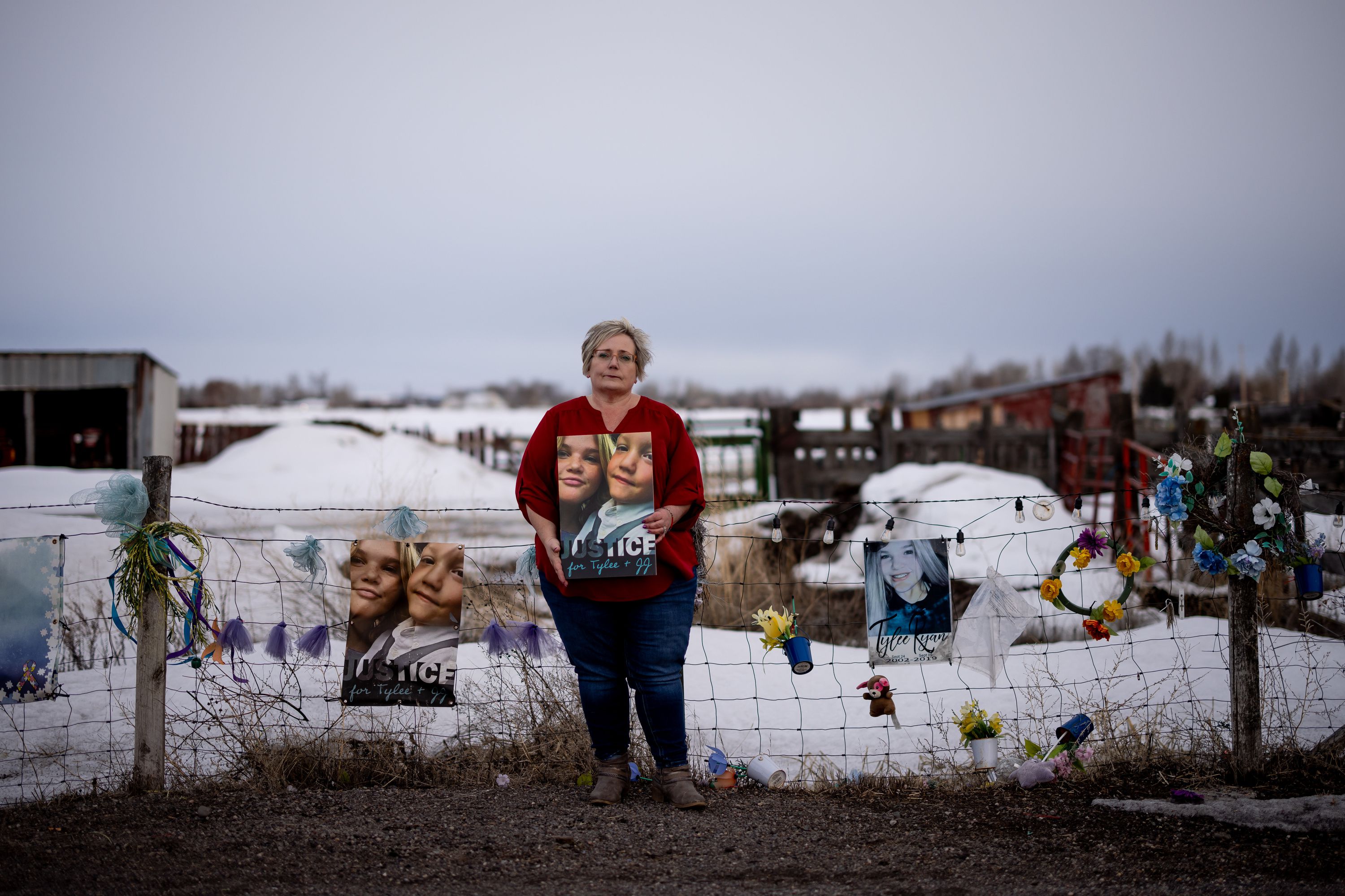 Peggy Jeppesen poses for a photo beside a memorial for Tylee Ryan and JJ Vallow, which she helped set up across the street from Chad Daybell’s property, in Salem, Idaho, on Wednesday.