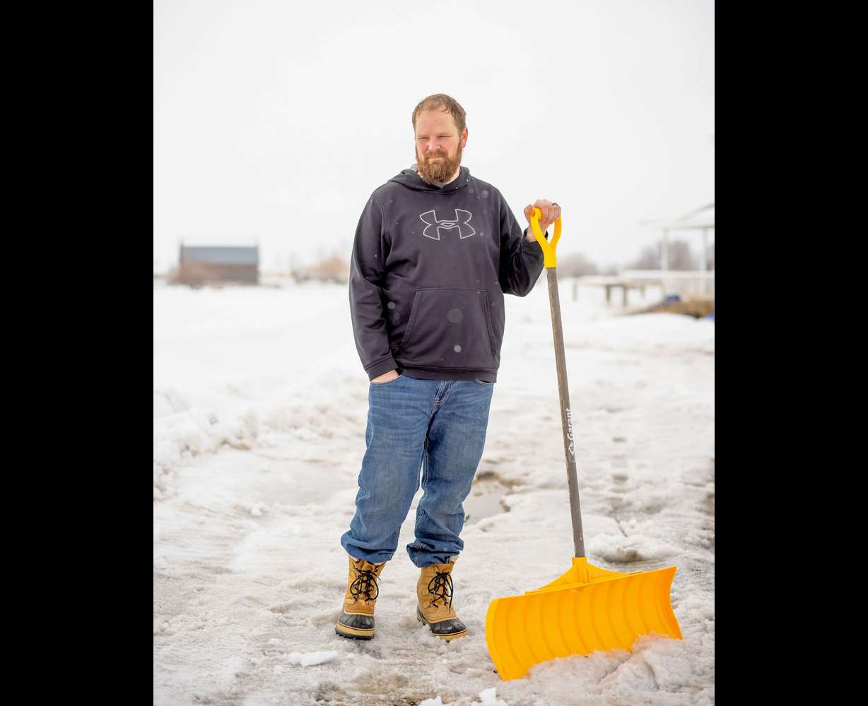Chris Tunnell, 47, pauses from shoveling his driveway on March 30, at his home in Salem, Idaho, just down the street from Chad Daybell’s property.