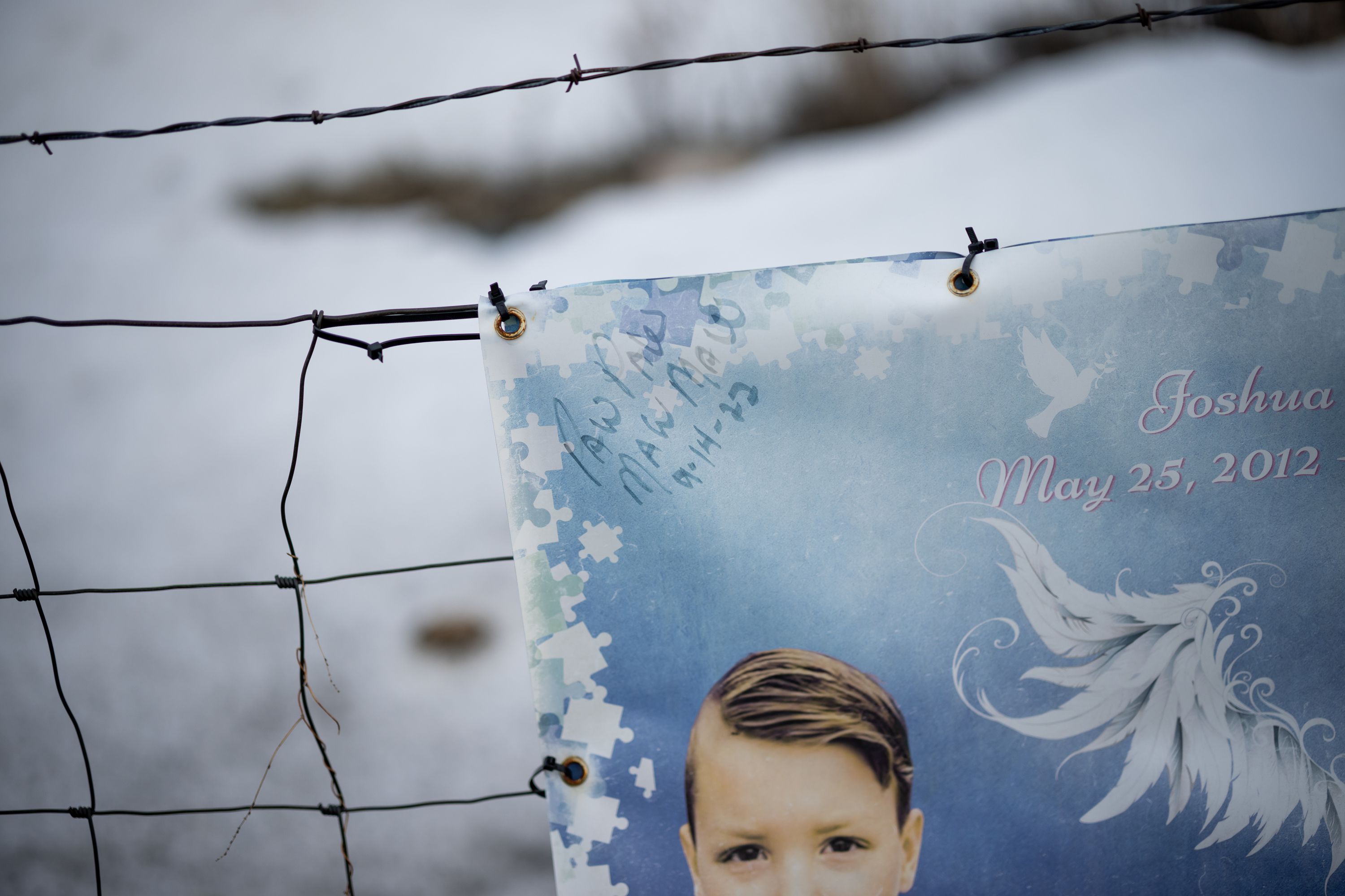 A sign that is part of a memorial to JJ Vallow, pictured at bottom, and Tylee Ryan bears the signatures of JJ’s grandparents, Kay and Larry Woodcock, who went by Paw Paw and Maw Maw to the children, on March 29.
