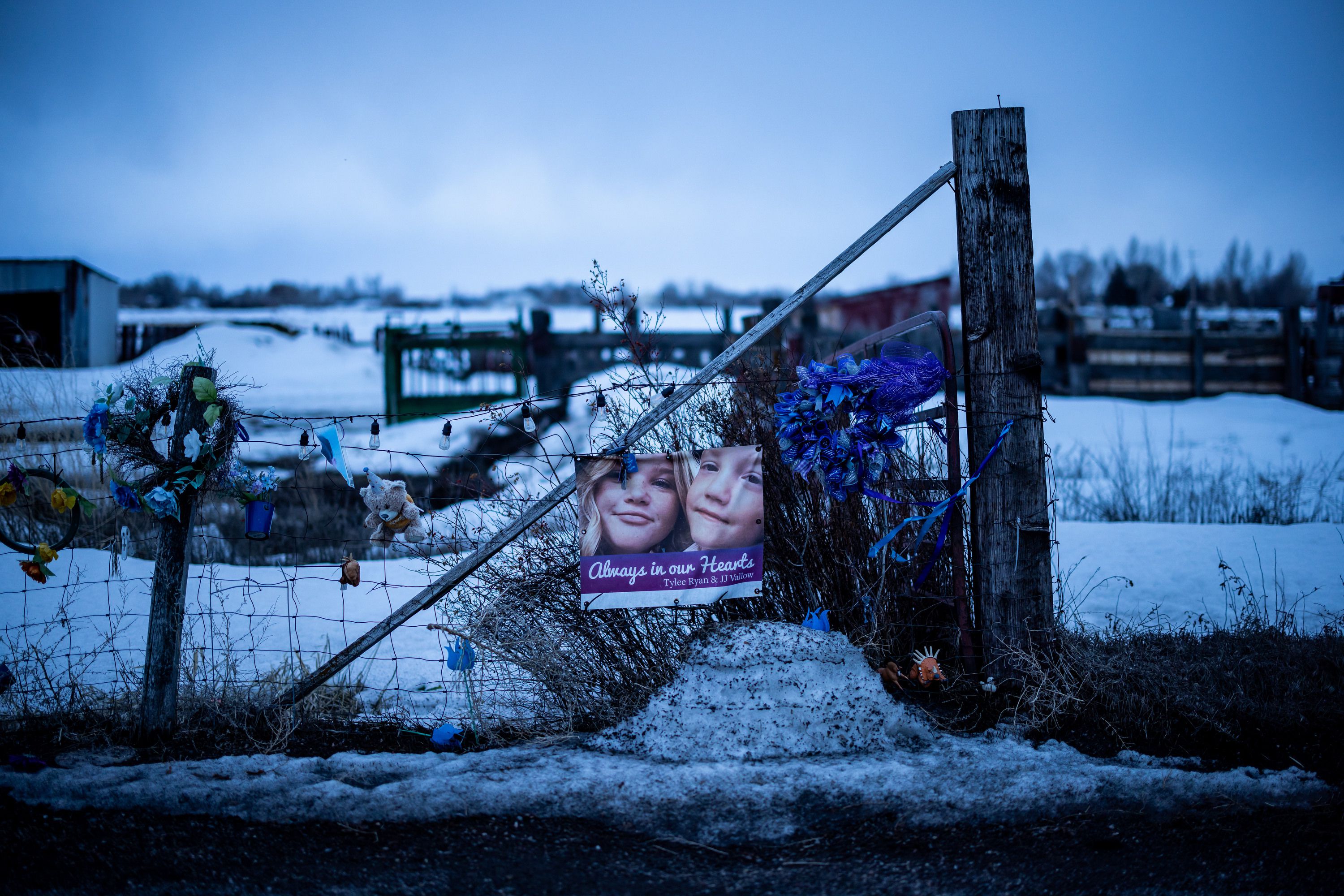 A memorial to Tylee Ryan and JJ Vallow is set up on a neighbor’s fence just across the street from Chad Daybell’s property in Salem, Idaho on March 29.