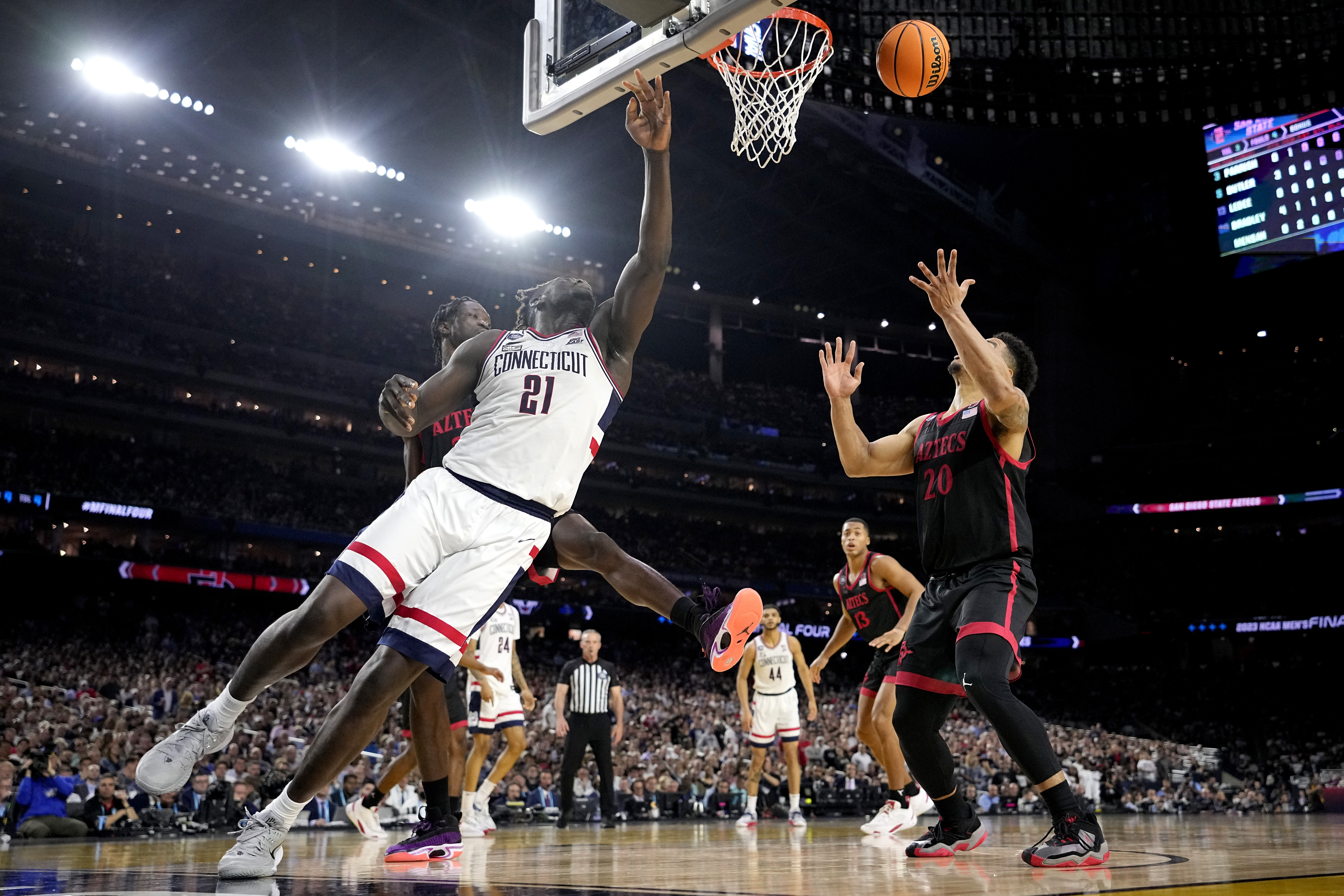 Connecticut forward Adama Sanogo (21) and San Diego State guard Matt Bradley vie for a rebound during the first half of the men's national championship college basketball game in the NCAA Tournament on Monday, April 3, 2023, in Houston. 