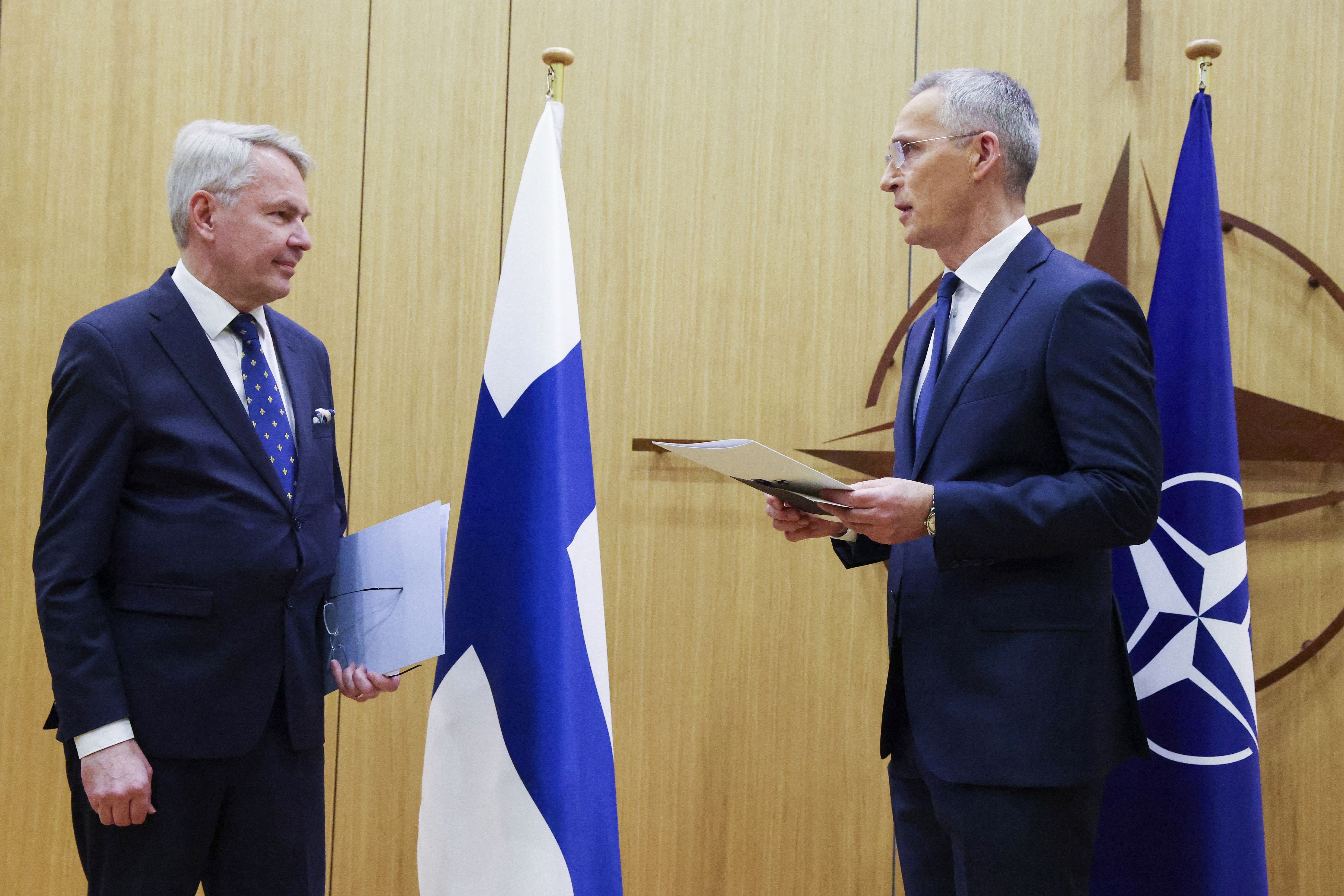 Finnish Foreign Minister Pekka Haavisto, left, speaks with NATO Secretary-General Jens Stoltenberg prior to handing over his nation's accession document during a meeting of NATO foreign ministers at NATO headquarters in Brussels, Tuesday. Finland joined the NATO military alliance on Tuesday.