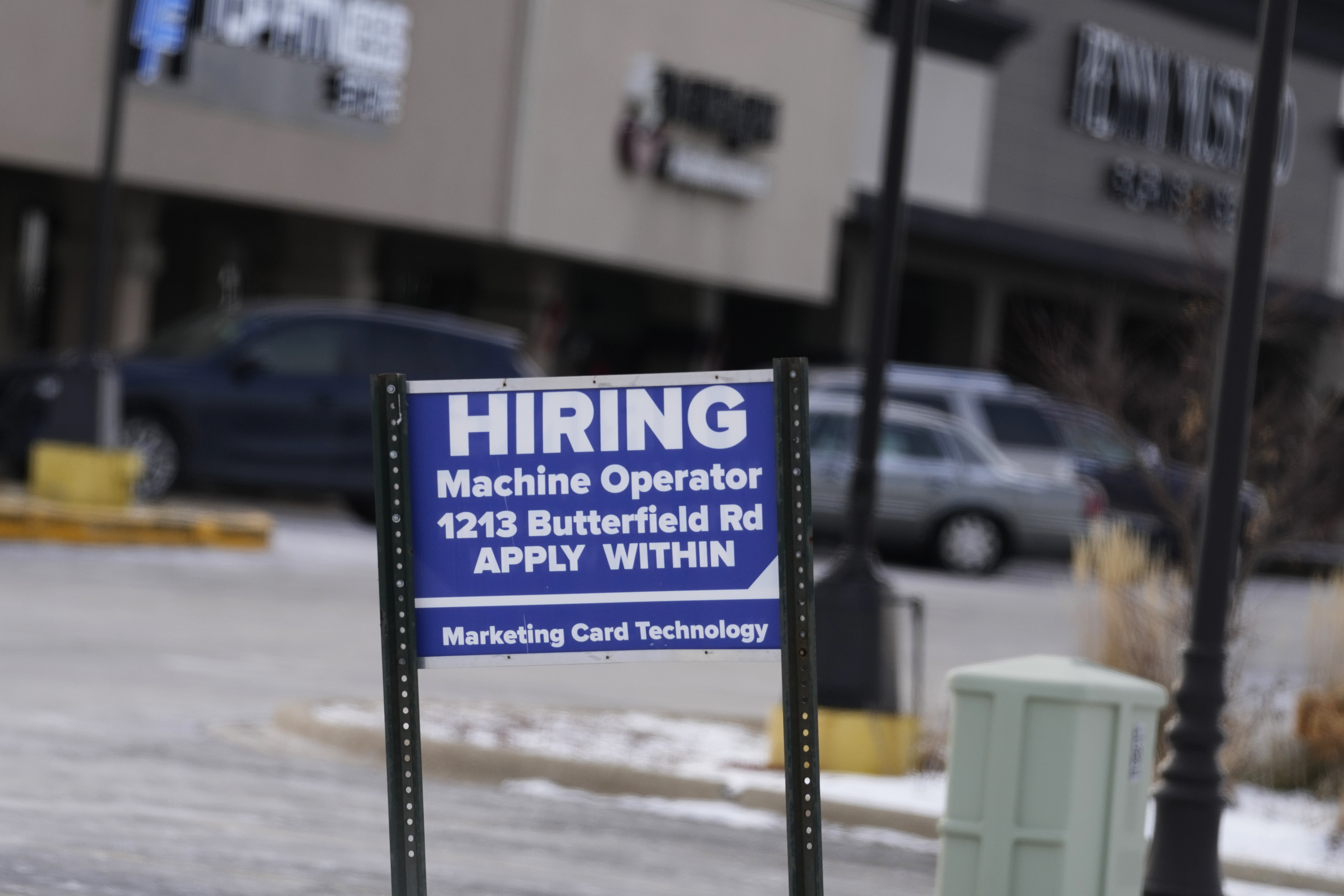A hiring sign is seen in Downers Grove, Ill., May 5, 2022. On Tuesday, the Labor Department said U.S. job openings slipped to 9.9 million in February.