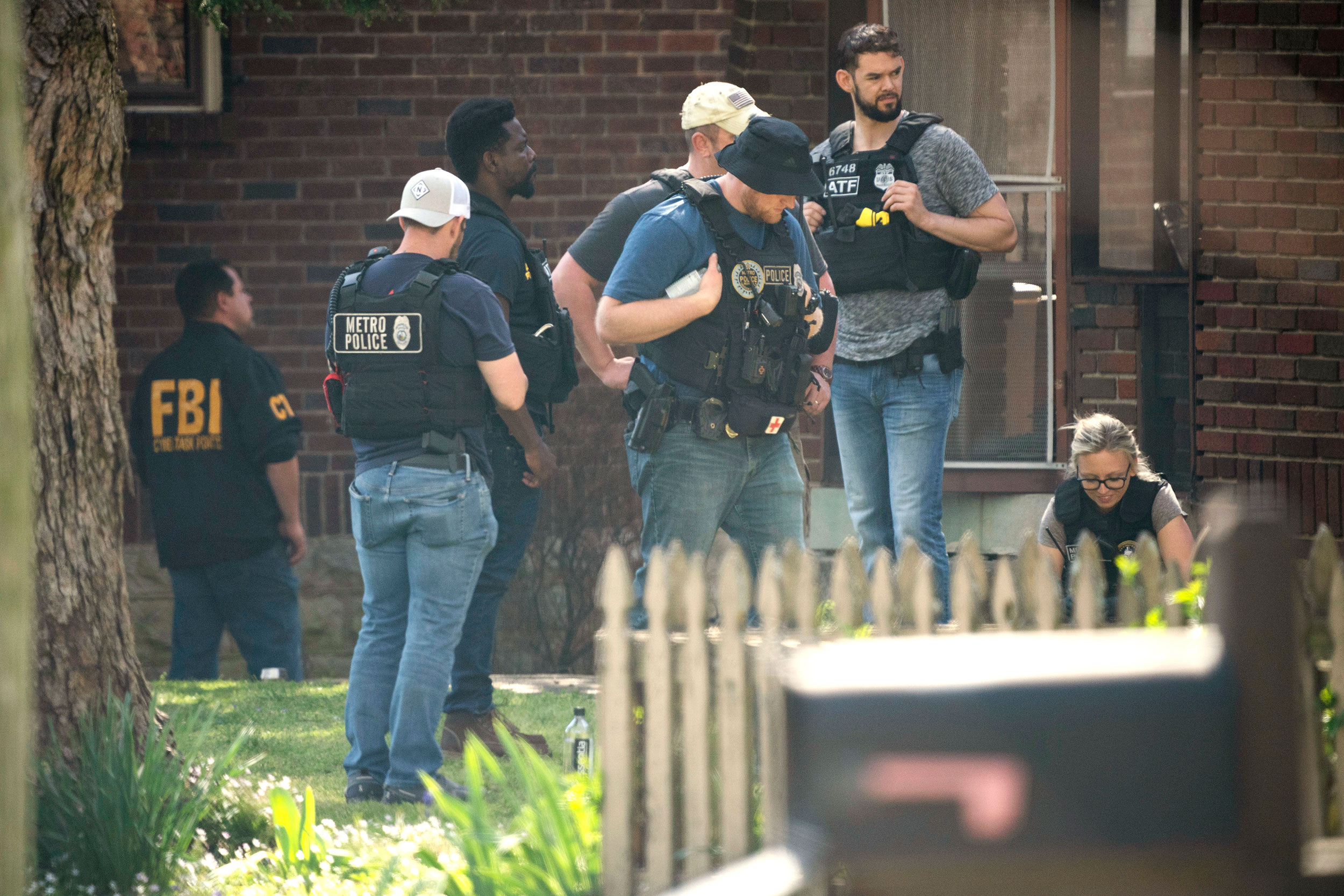 Metro Nashville Police and the FBI search and investigate a house following a mass shooting at Covenant School, on Monday, March 27, in Nashville, Tennessee.