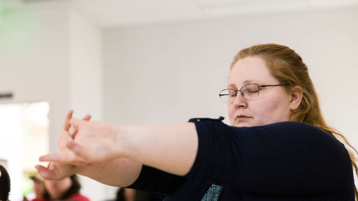 Rachel Leonard, who has autism, practices a relaxation technique during the Passages Program class at the Melisa Nellesen Center for Autism at Utah Valley University in Orem on Monday.
