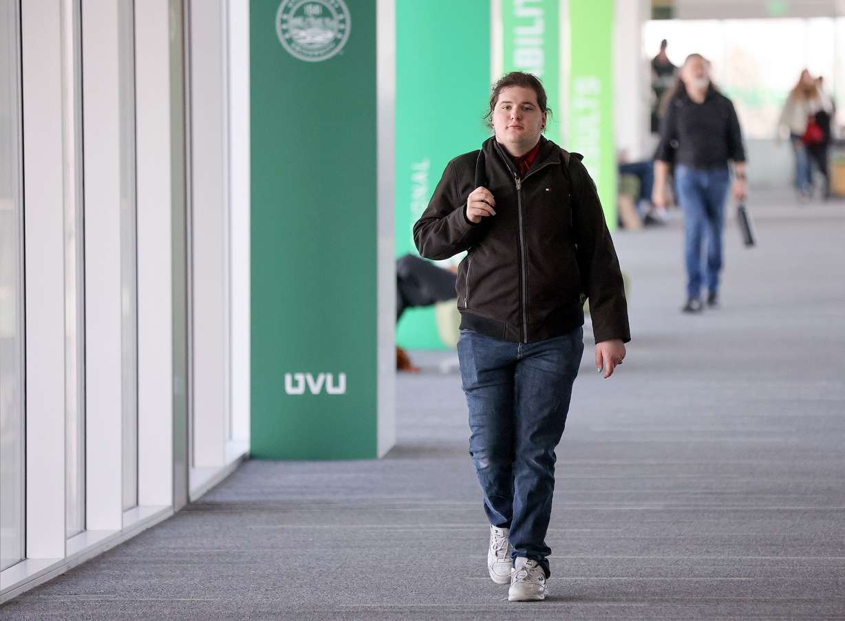 Fish Vosnos, who has autism and is pursuing a degree in autism studies, walks through campus at Utah Valley University in Orem on March 28.