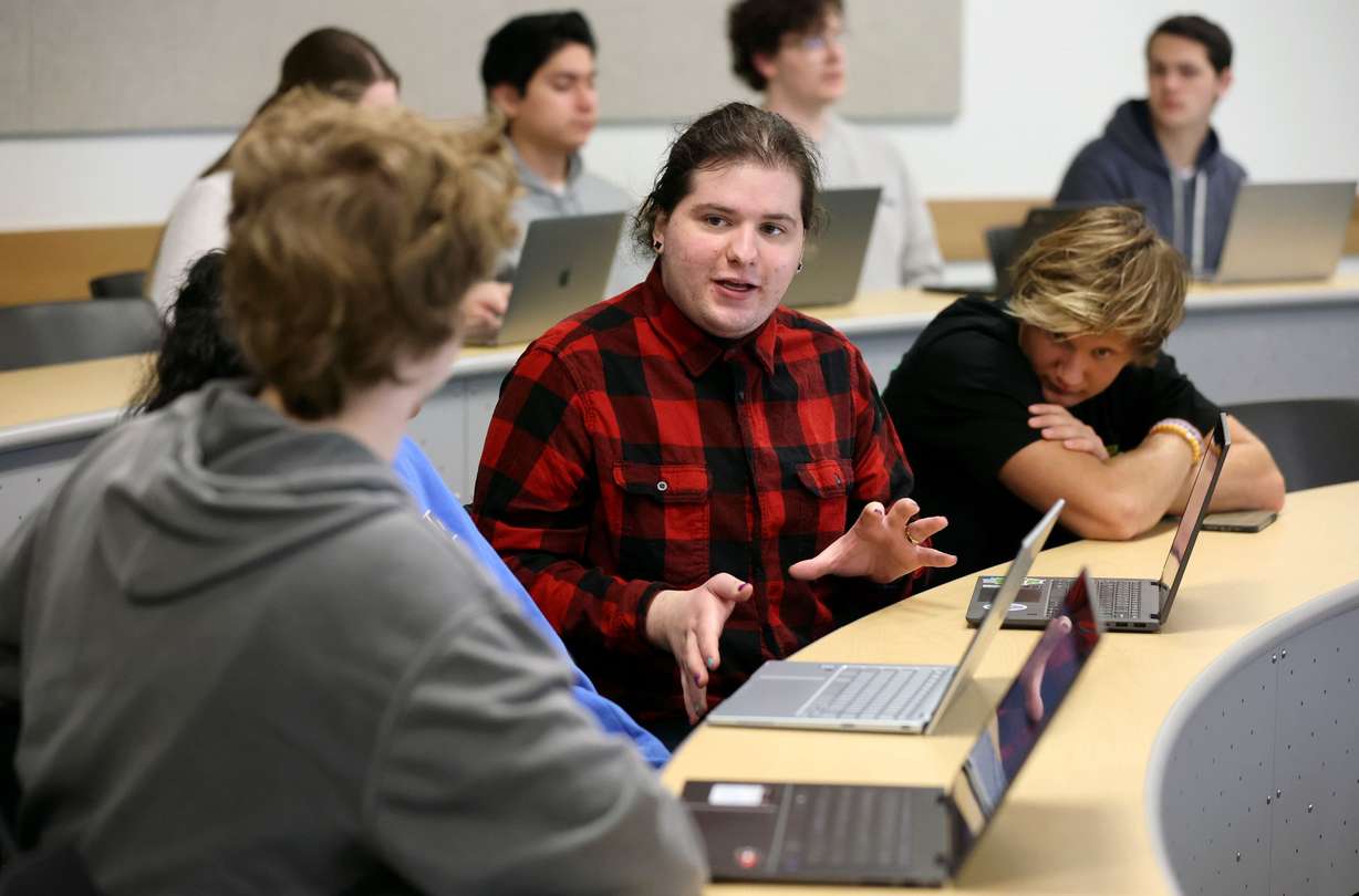 Fish Vosnos, who has autism and is pursuing a degree in autism studies, talks with his classmates during an English 1005, rhetorics and literacies across communities, class at Utah Valley University in Orem on March 28.