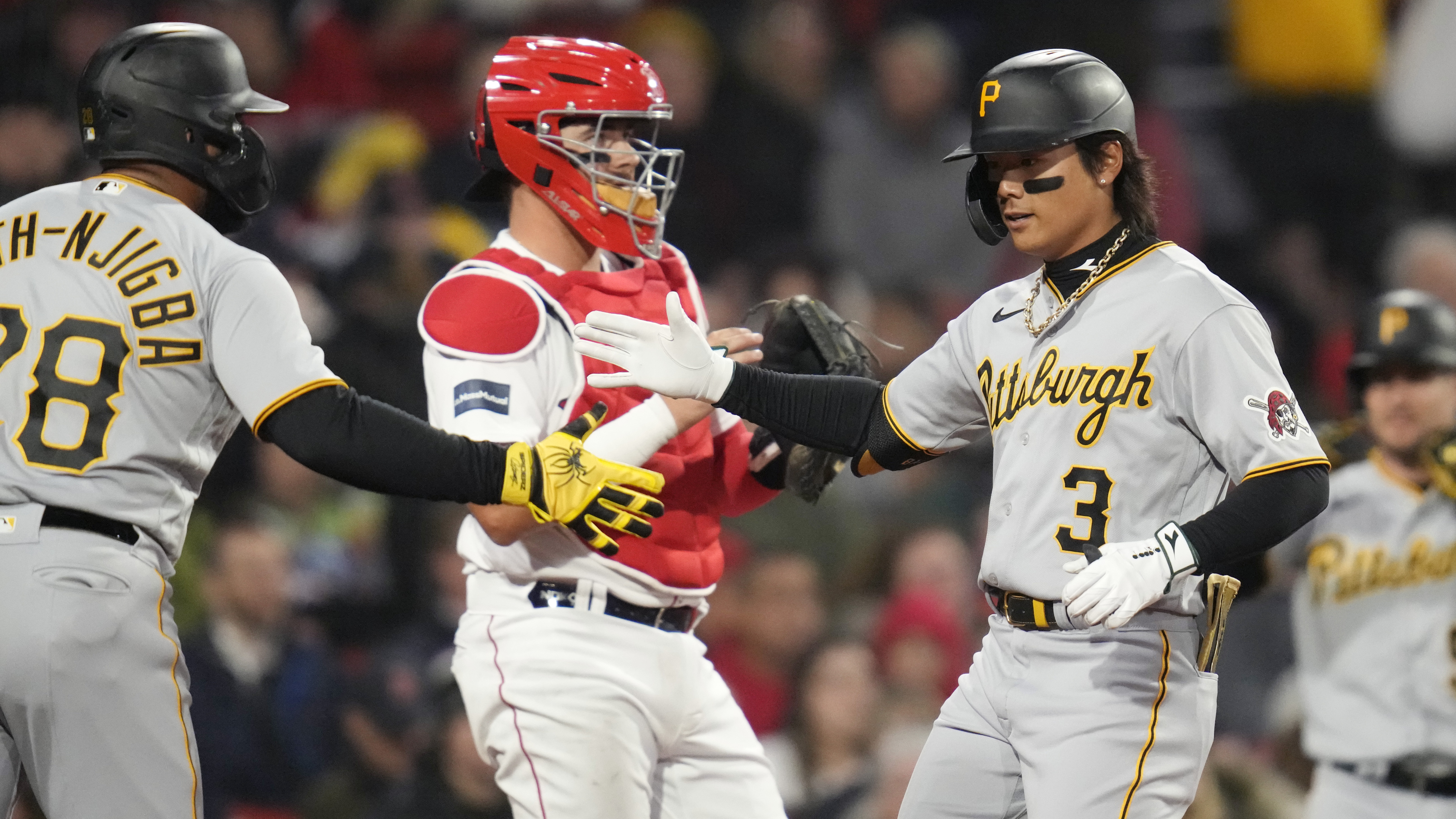 Pittsburgh Pirates' Ji Hwan Bae, right, is congratulated by Canaan Smith-Njigba after his two run, home run during the second inning of a baseball game against the Boston Red Sox at Fenway Park, Tuesday, April 4, 2023, in Boston. At center is Boston Red Sox catcher Reese McGuire. 