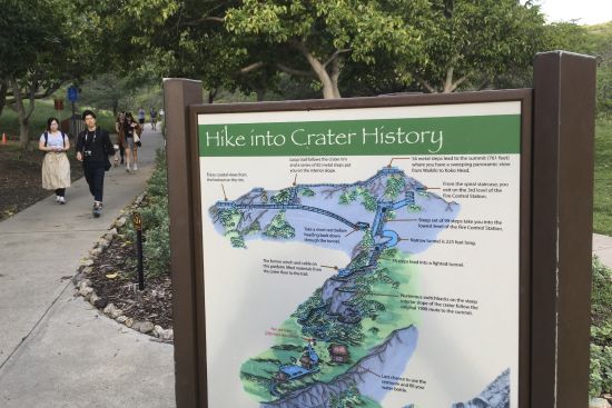 People walk down a pathway at the Diamond Head State Monument in Honolulu, on Jan. 16, 2018. Taking care of Hawaii's unique natural environment costs money and now the state wants tourists to help pay for it, especially because growing numbers are traveling to the islands to enjoy the beauty of its outdoors — including some lured by dramatic vistas they've seen on social media.