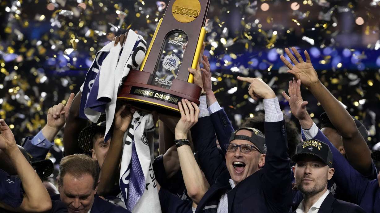 Connecticut head coach Dan Hurley celebrates with the trophy after their win against San Diego State in the men's national championship college basketball game in the NCAA Tournament on Monday, April 3, 2023, in Houston.