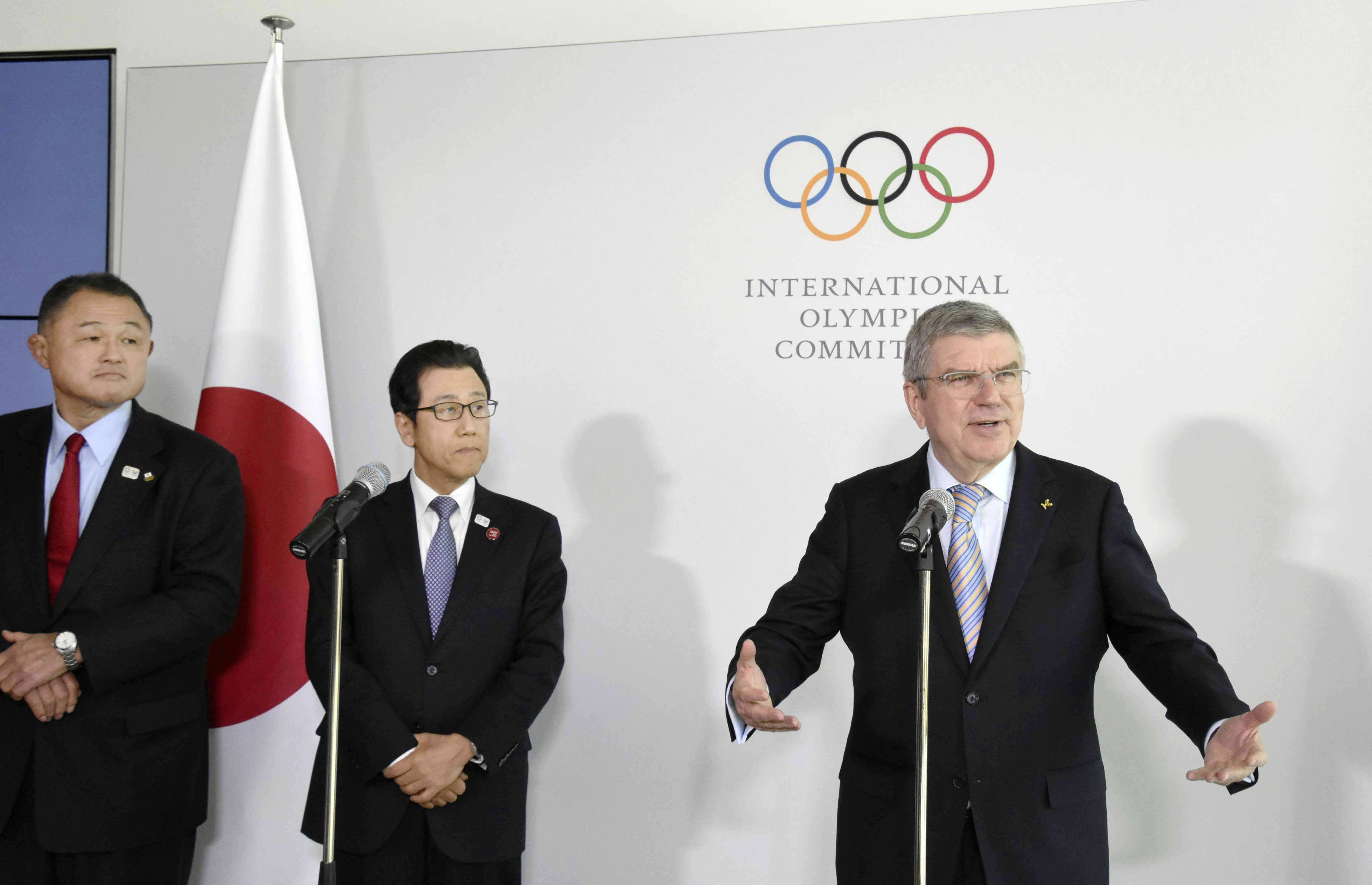 Japanese Olympic Committee President Yasuhiro Yamashita, from left, and Sapporo Mayor Katsuhiro Akimoto listen to International Olympic Committee President Thomas Bach, right, speak during a news conference in Lausanne, Switzerland, on Jan. 11, 2020. Sapporo's bid for the 2030 Winter Olympics has been slowed, but not stopped, by fallout from the still-developing corruption scandal around the 2020 Tokyo Games. 