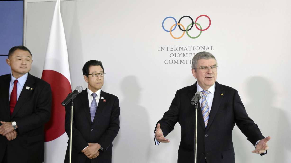 Japanese Olympic Committee President Yasuhiro Yamashita, from left, and Sapporo Mayor Katsuhiro Akimoto listen to International Olympic Committee President Thomas Bach, right, speak during a news conference in Lausanne, Switzerland, on Jan. 11, 2020. Sapporo's bid for the 2030 Winter Olympics has been slowed, but not stopped, by fallout from the still-developing corruption scandal around the 2020 Tokyo Games.