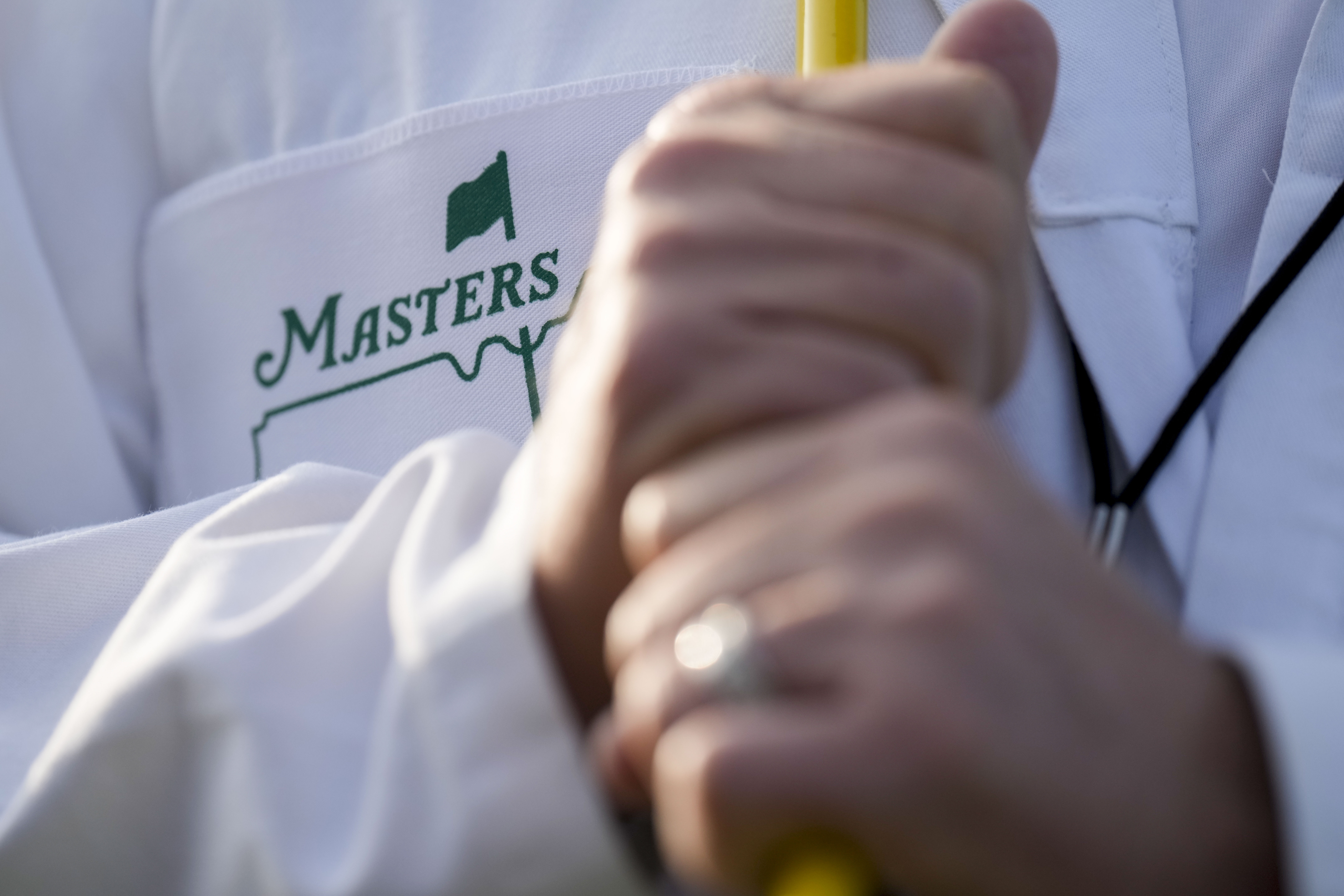 A forecaddie stands on the first hole during a practice round for the Masters golf tournament at Augusta National Golf Club on Wednesday, April 5, 2023, in Augusta, Ga. 