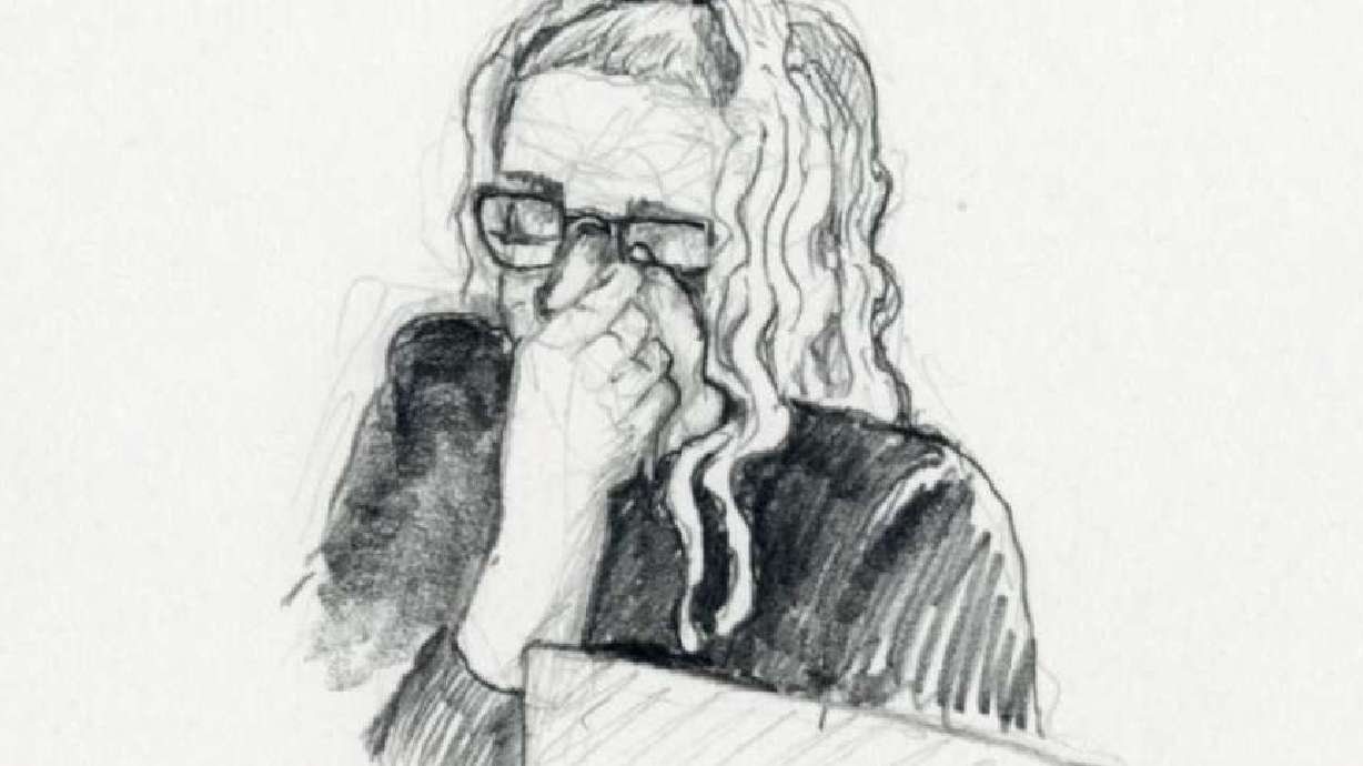 Lori Vallow Daybell appears to wipe her eyes or wipe her glasses during jury selection Wednesday in Boise, Idaho.