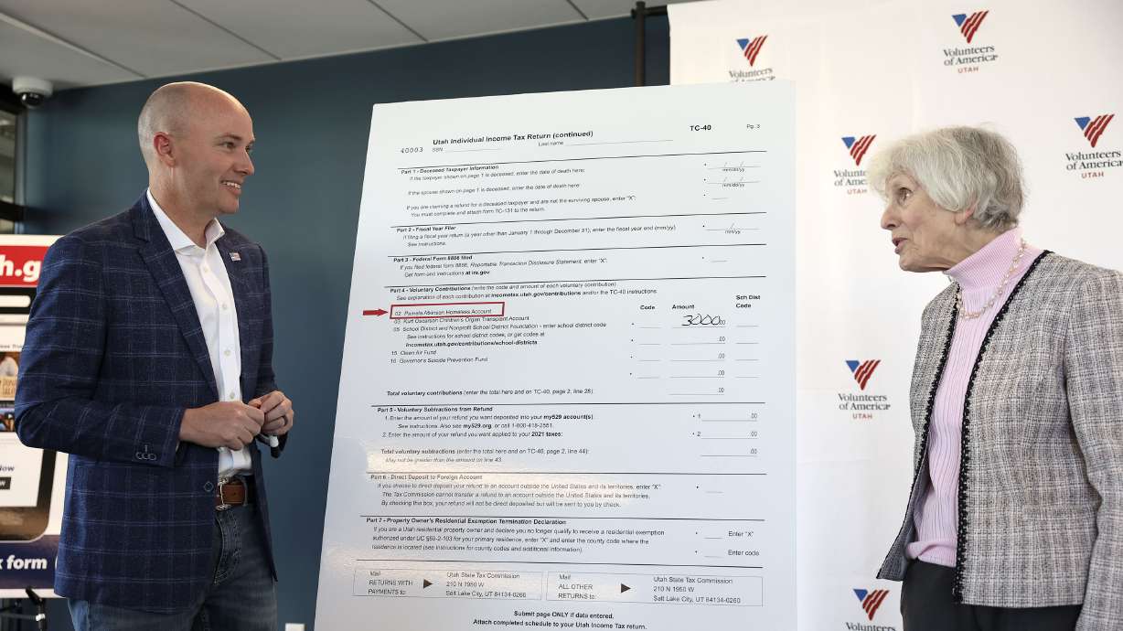 Gov. Spencer Cox and Pamela Atkinson, an adviser to Cox and community advocate, laugh together in Salt Lake City on Thursday. The two are encouraging every Utahn who is filing taxes to donate $3 to the Pamela Atkinson Homeless Trust Fund.