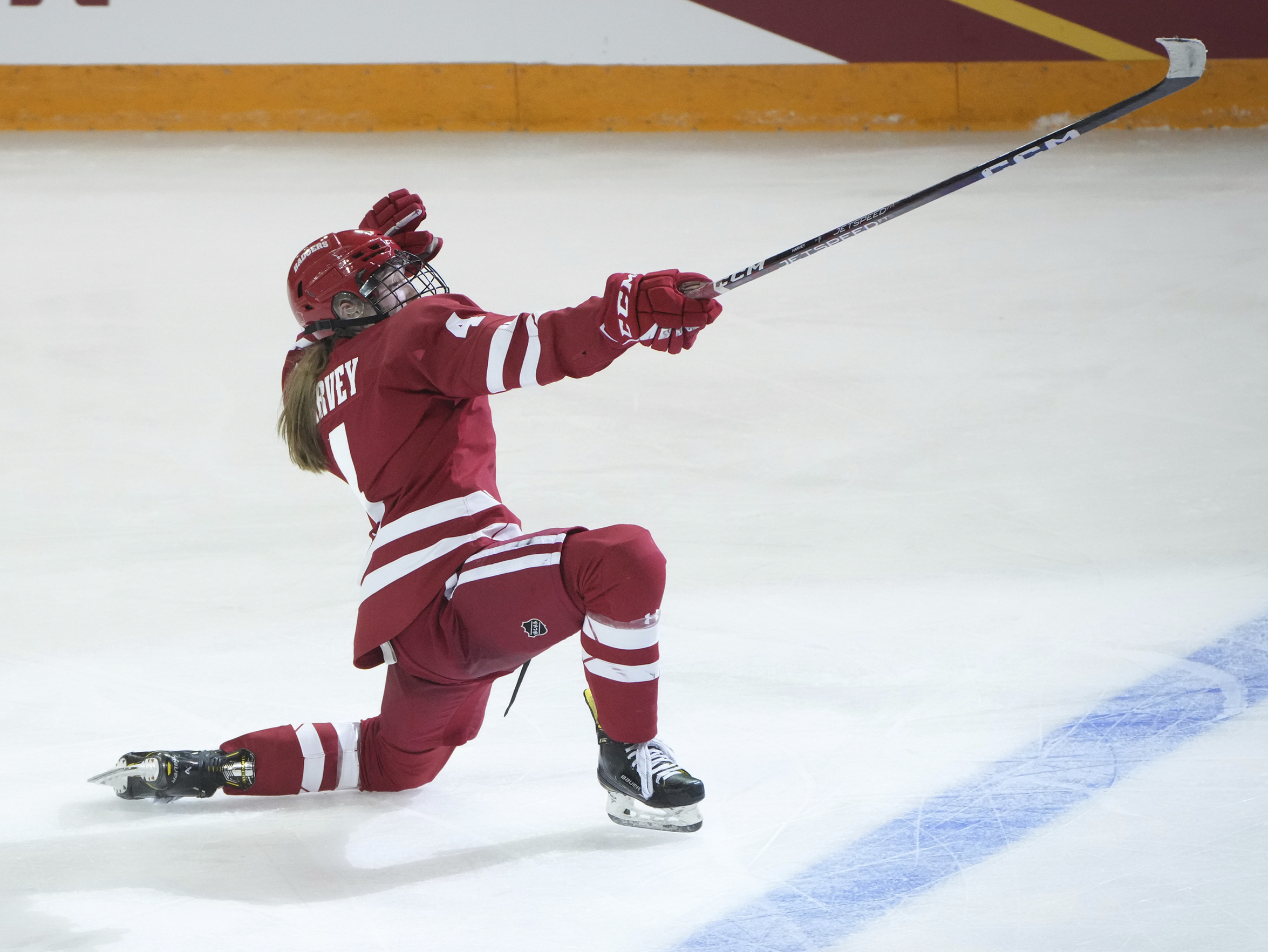 FILE - Wisconsin defenseman Caroline Harvey (4) celebrates after scoring in overtime against Minnesota in an NCAA Frozen Four semifinal in Duluth, Minn., Friday, March 17, 2023. In 13 short months, United States defender Caroline Harvey has put aside a lack of playing time at the Beijing Winter Games to winning an NCAA Tournament title to close her freshman season at Wisconsin and establishing herself as key fixture on a young, retooling American team at the women's world hockey championships. 